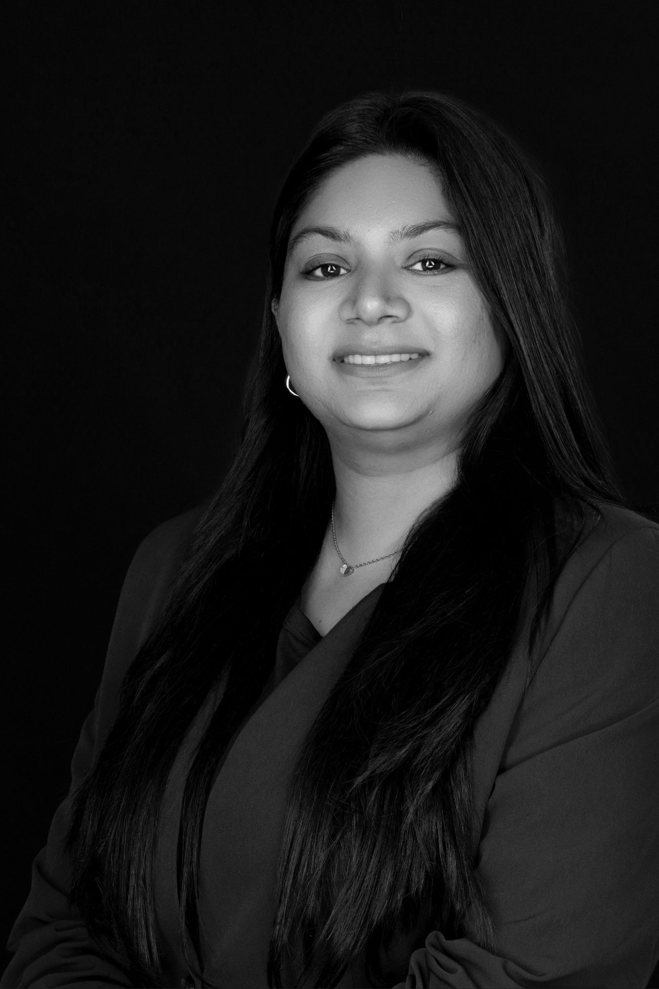 Black and white portrait series showing different angles of a person with long dark hair against a dark background.