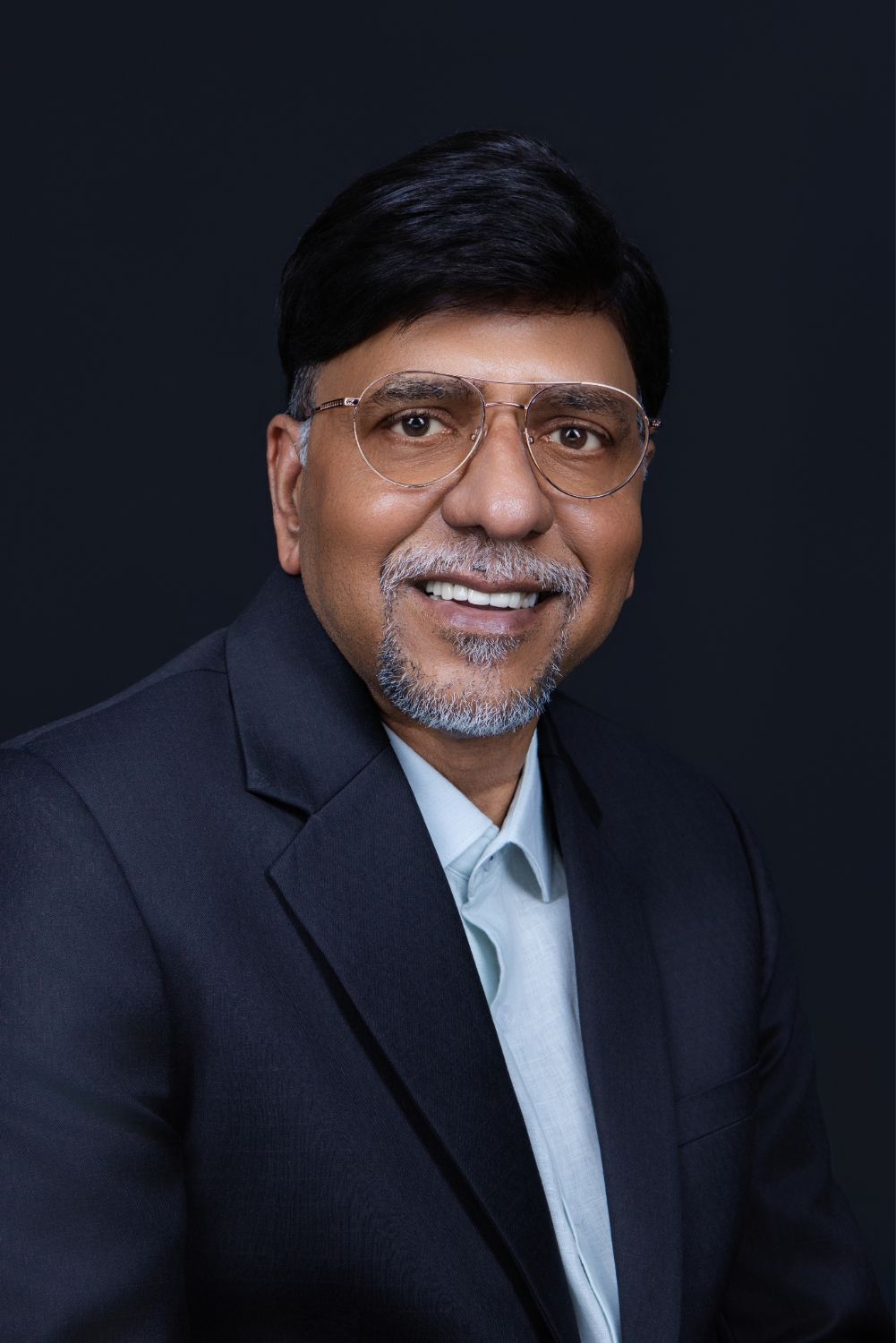 Professional headshot series showing expressions from serious to smiling against dark background.