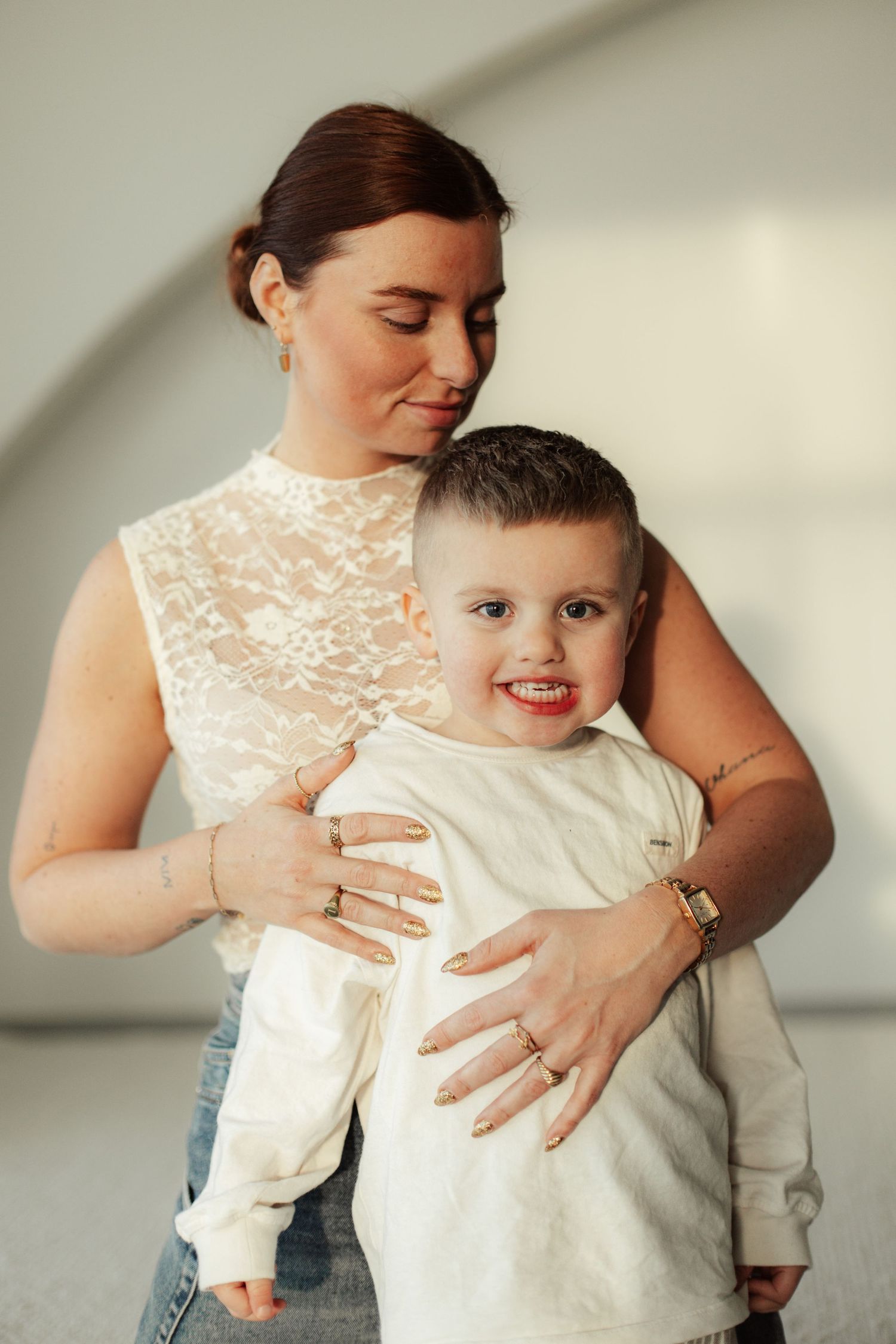 Tender moment between parent and child in studio with soft lighting.