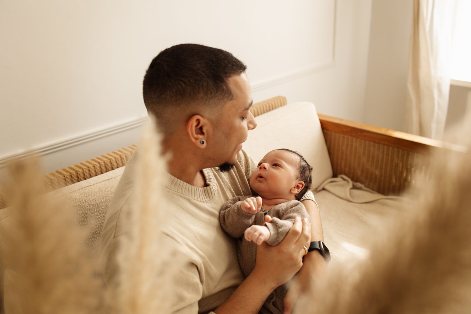 A series of tender moments captured between parent and baby in warm, natural lighting.