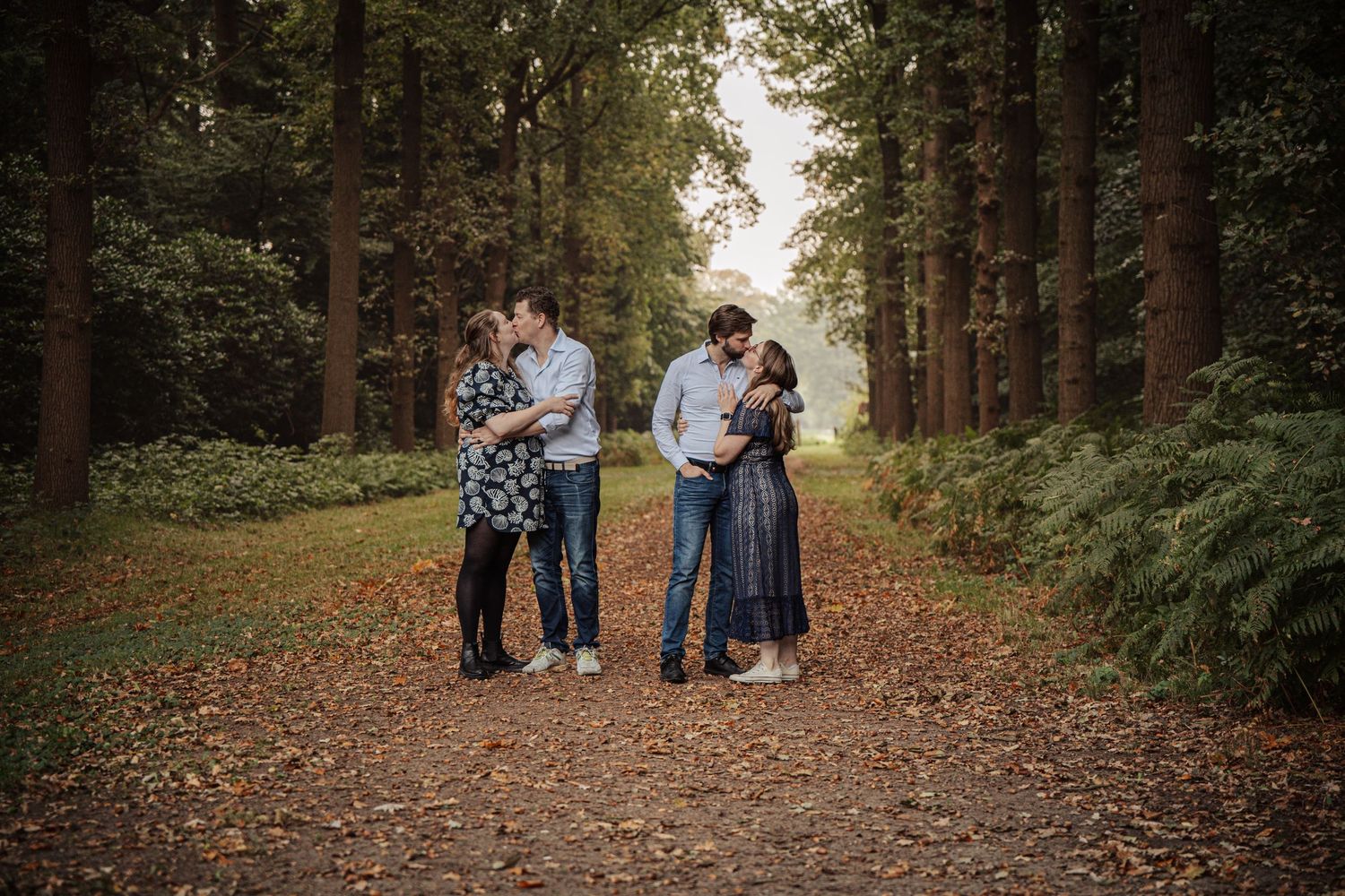 Extended family portrait session in a wooded forest setting during fall.