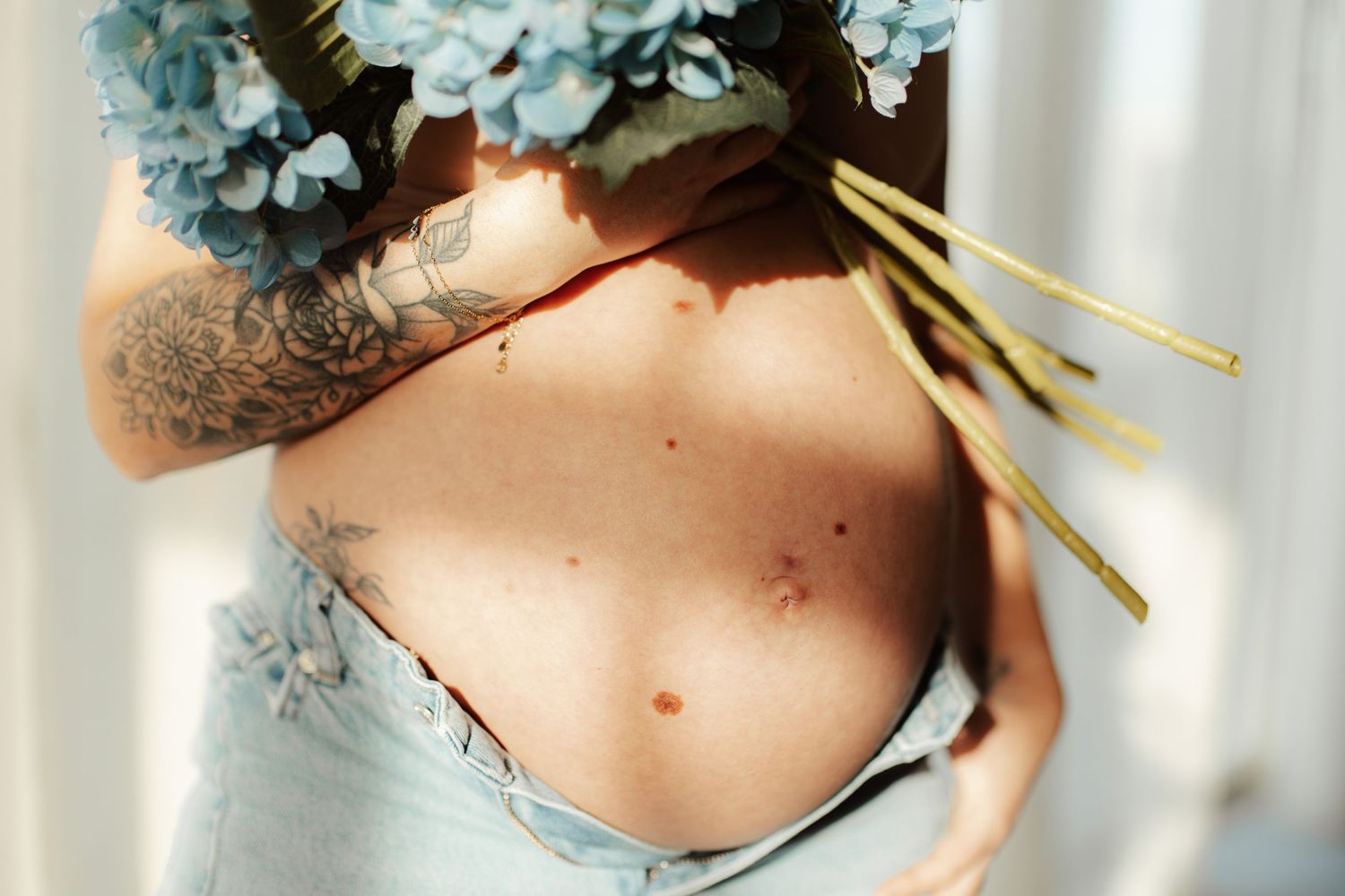 Close-up portrait with delicate blue flowers and golden accents.
