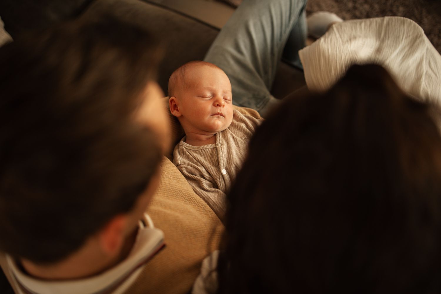 Intimate lifestyle photography session in soft, moody lighting.