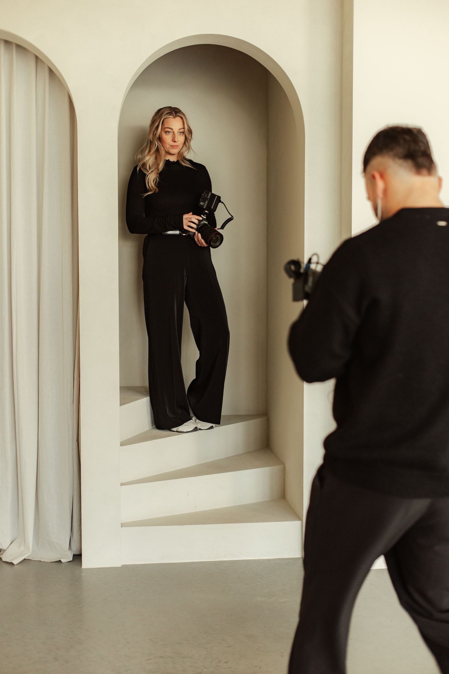Studio photography sequence showing interaction between photographer and subject in arched alcoves.