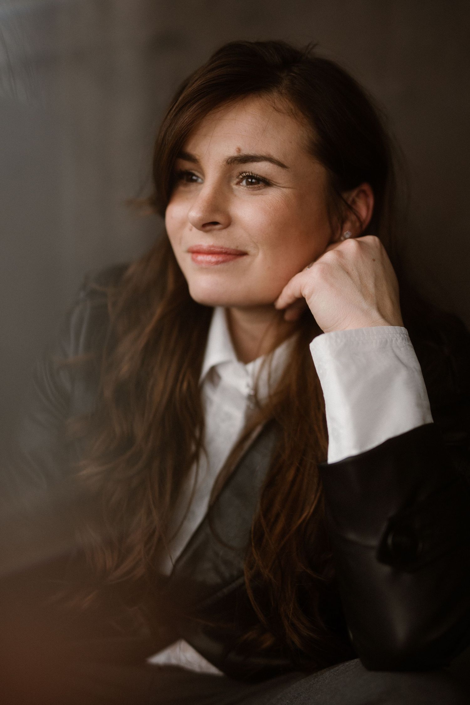 Artistic portrait sequence showing contemplative poses in dark, atmospheric lighting.