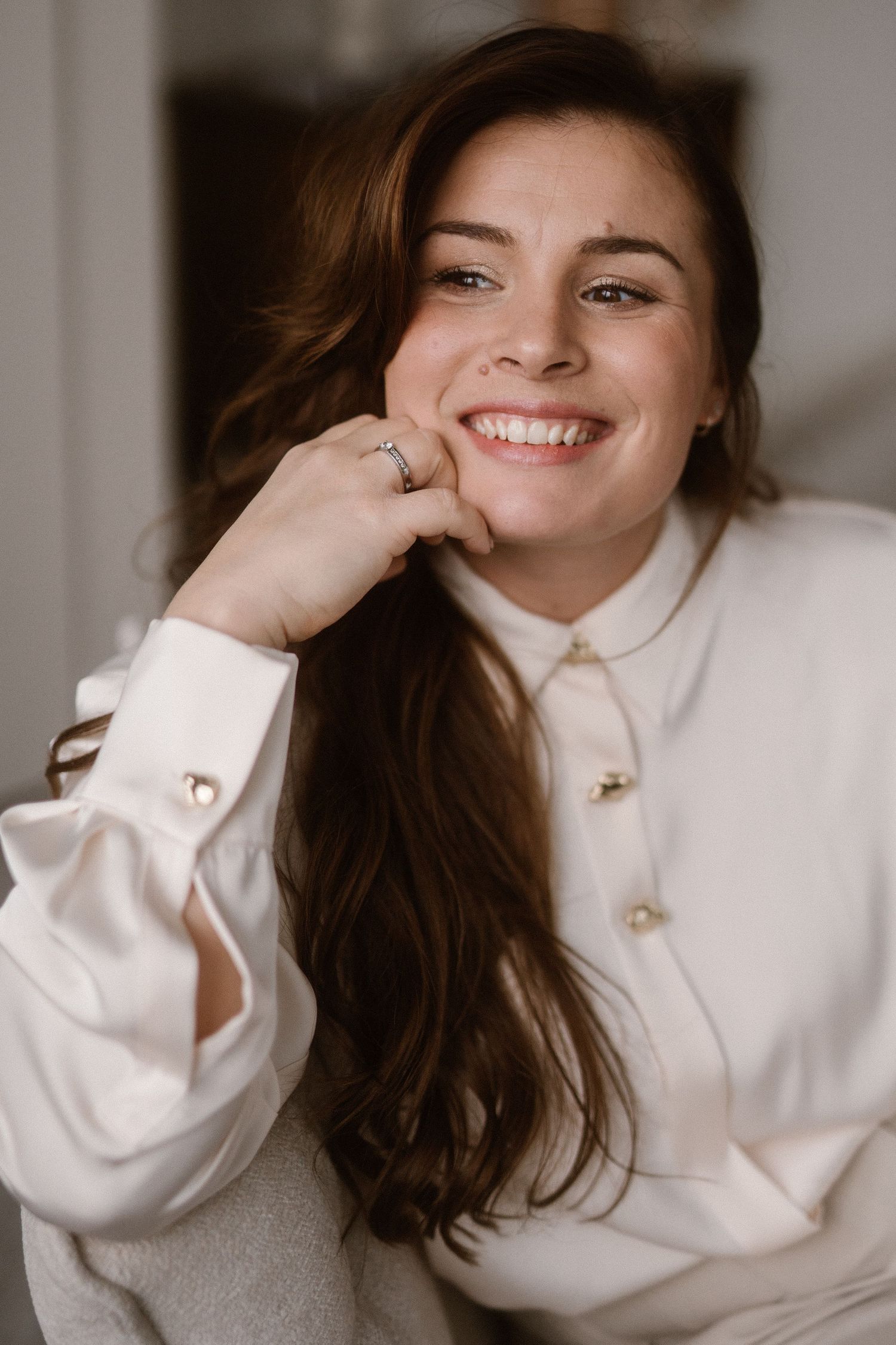 Cozy indoor portrait series in white button-down shirt with natural expressions.