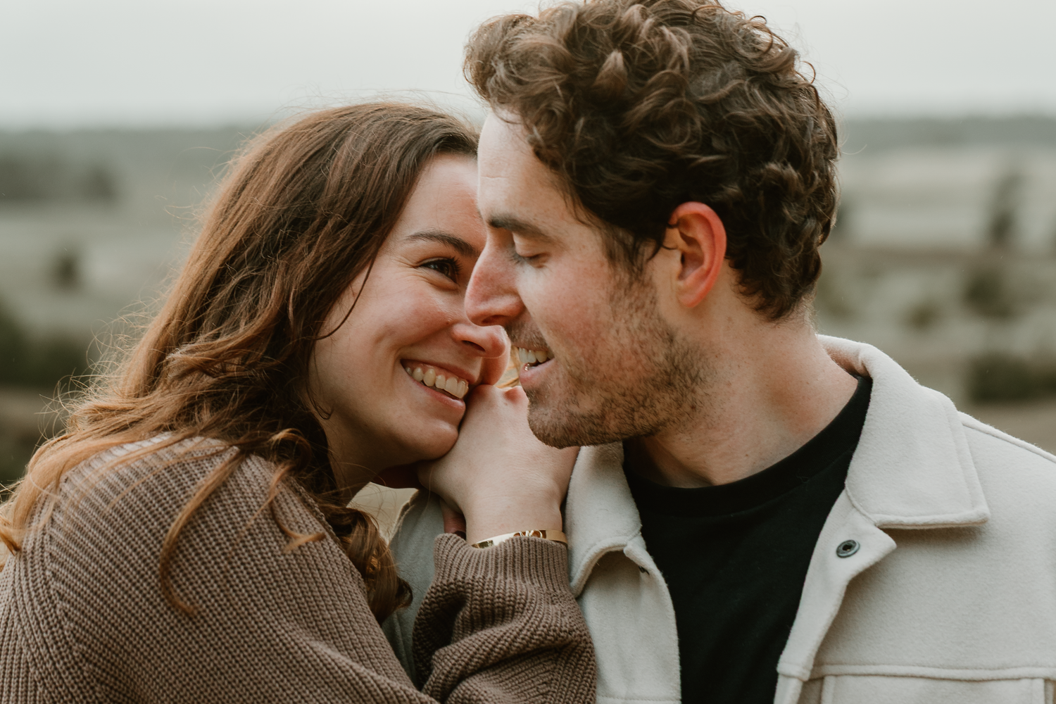 Intimate moment between couple in soft natural lighting.