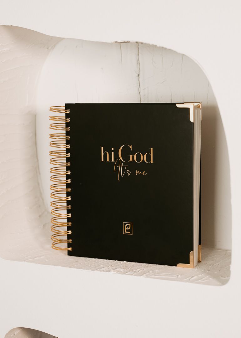 Black spiral-bound journal with gold accents and 