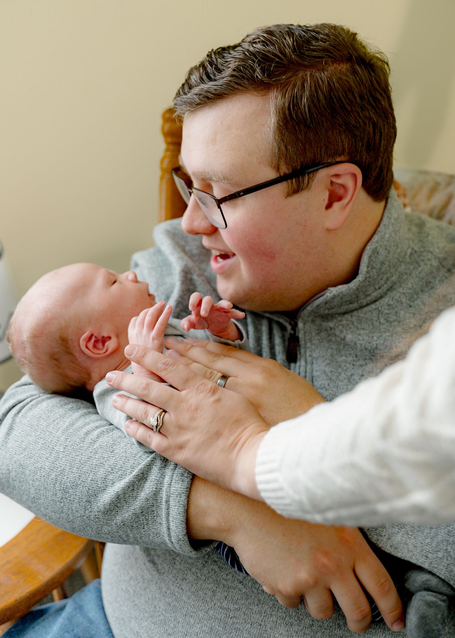 A series of tender moments showing a parent cradling and bonding with their infant.