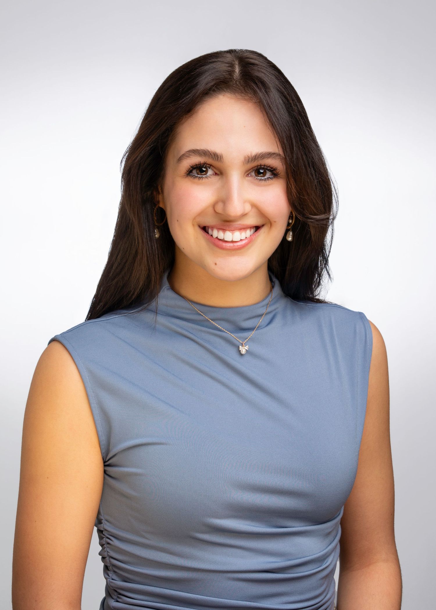 Studio portraits in a grey sleeveless top against white background.