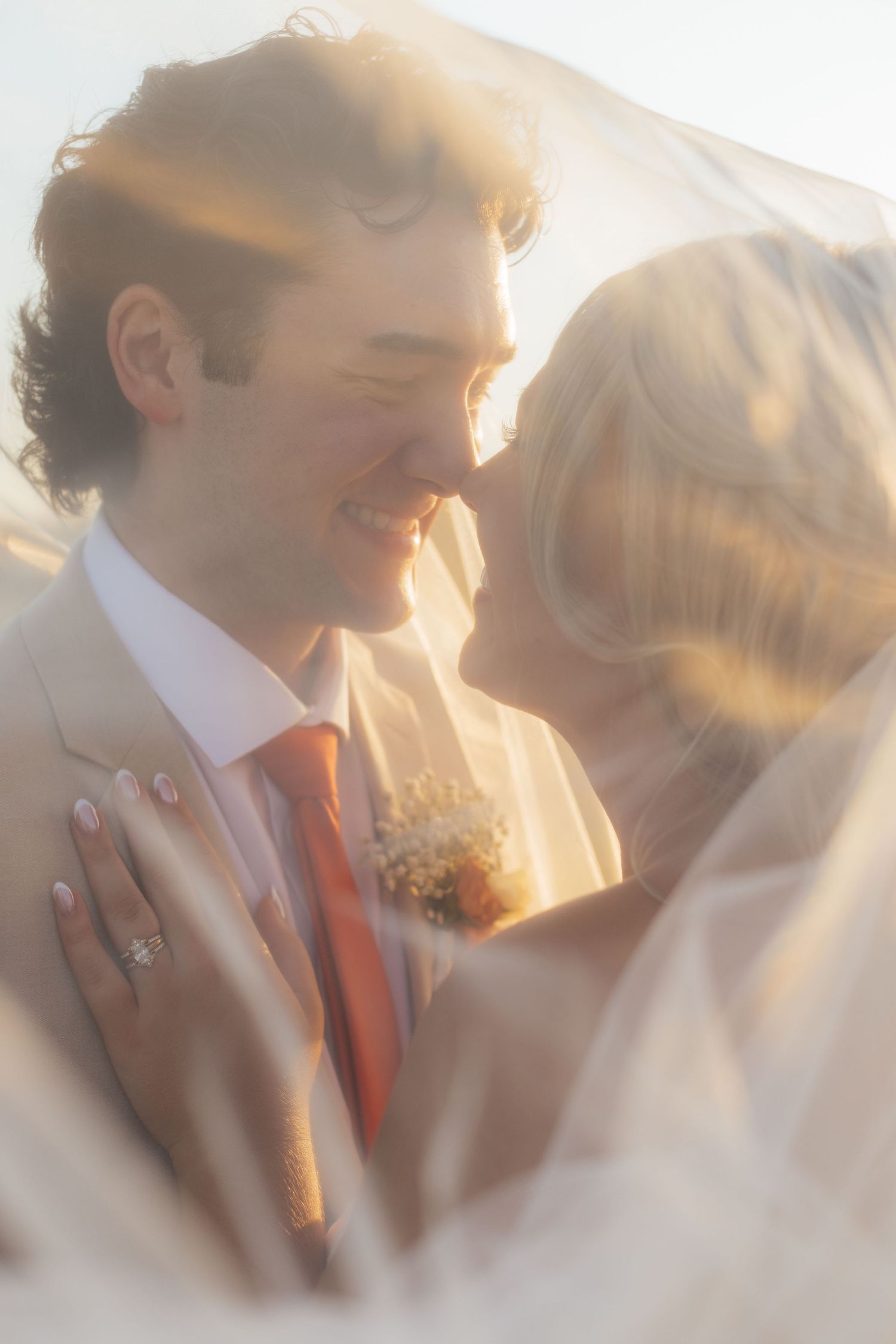 Soft focus romantic wedding portrait captured in dreamy golden light.