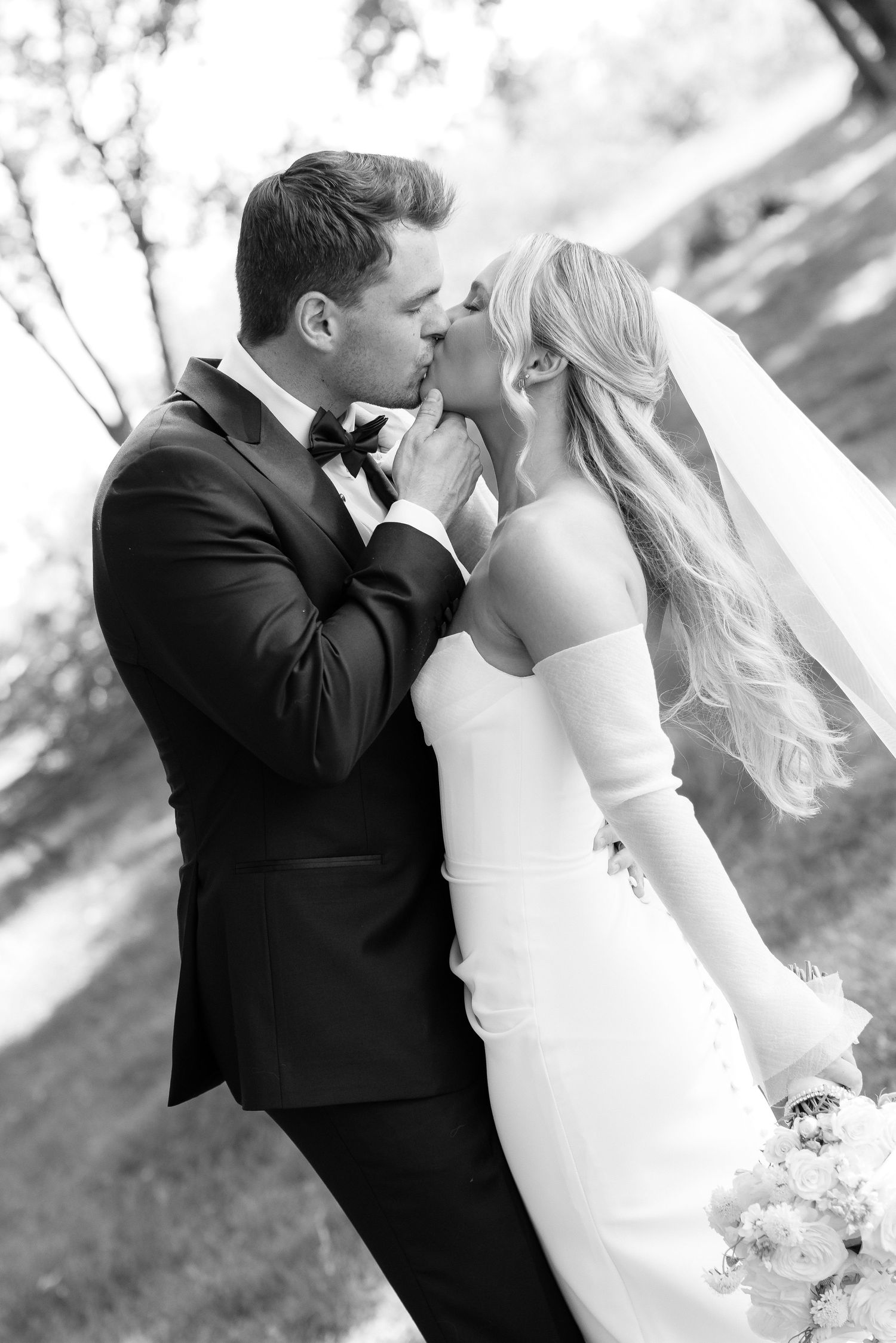Artistic black and white wedding photos showing intimate moments between newlyweds.
