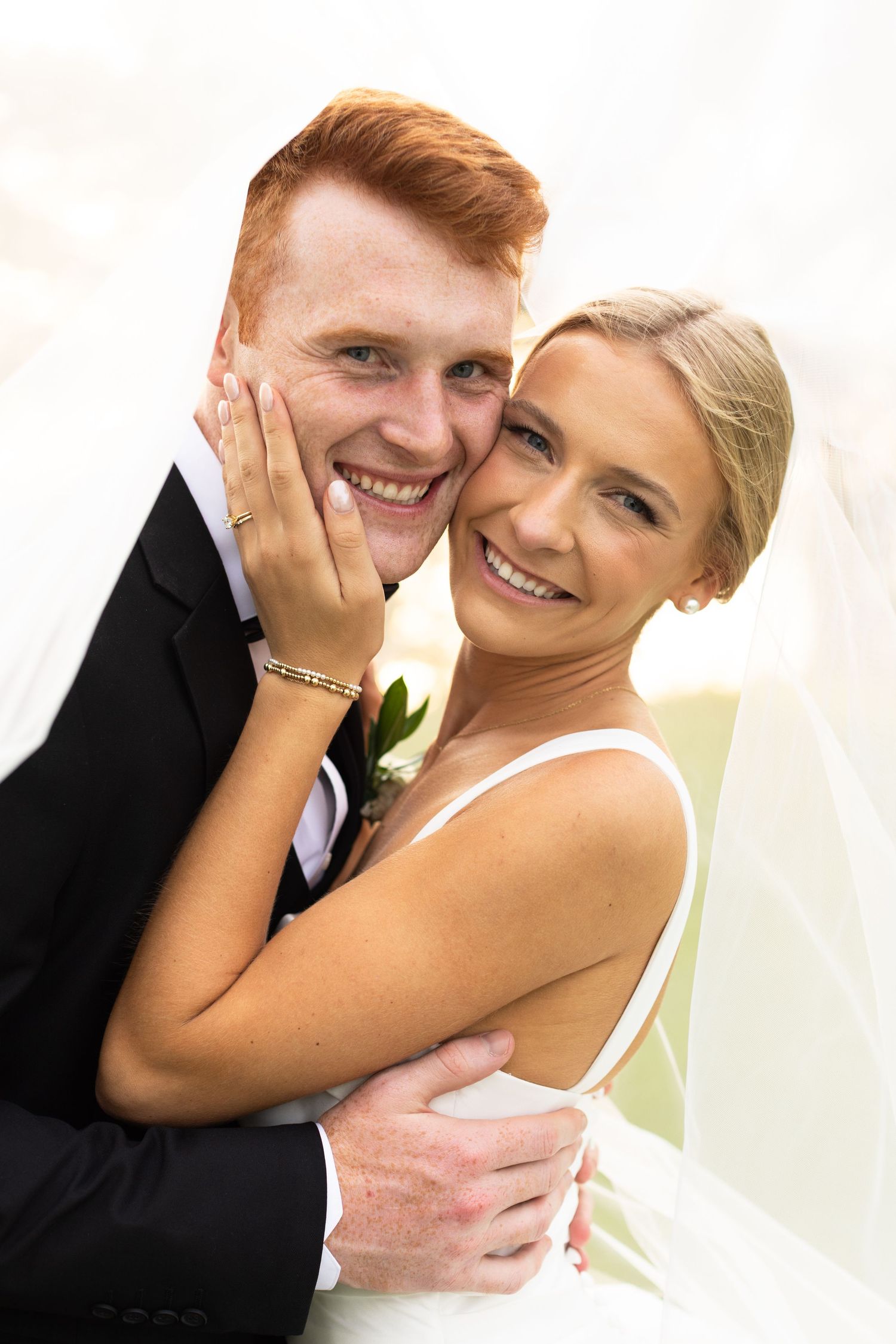 Close-up of joyful wedding couple sharing tender moments together.