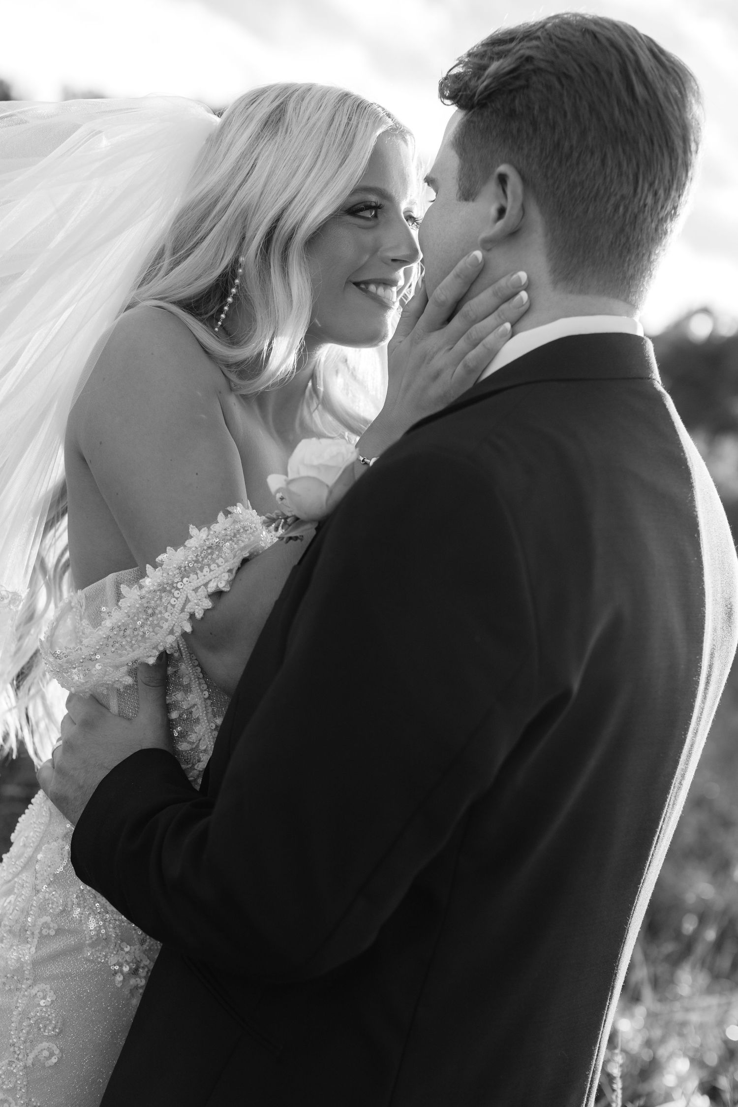 Romantic black and white wedding portrait series showing intimate moments between newlyweds.