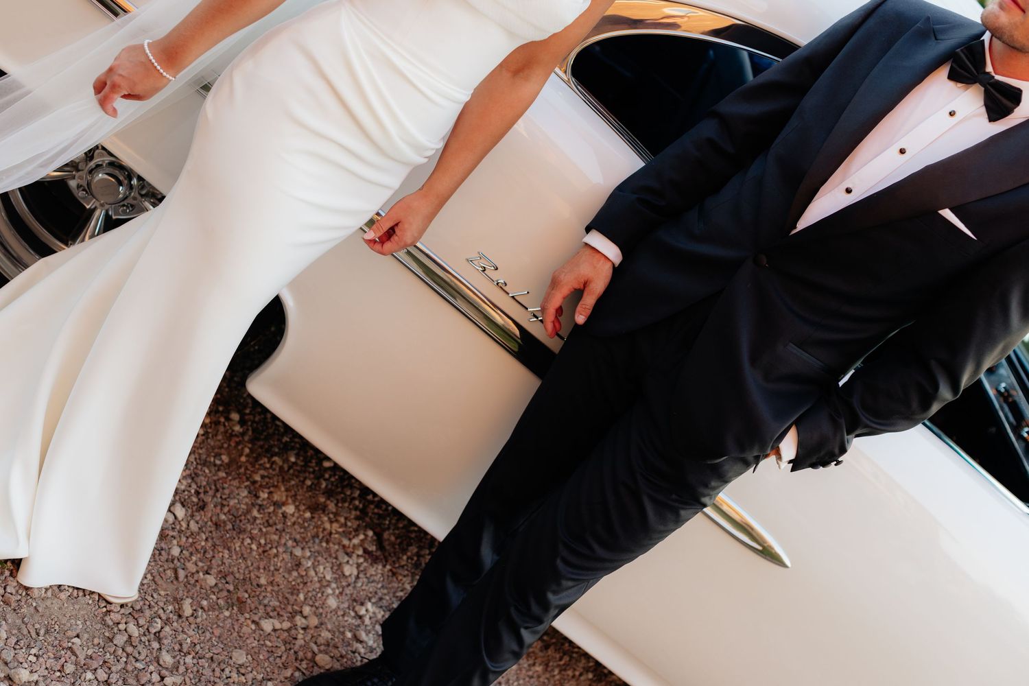 Cropped detail shot of bride and groom's formal wedding attire.