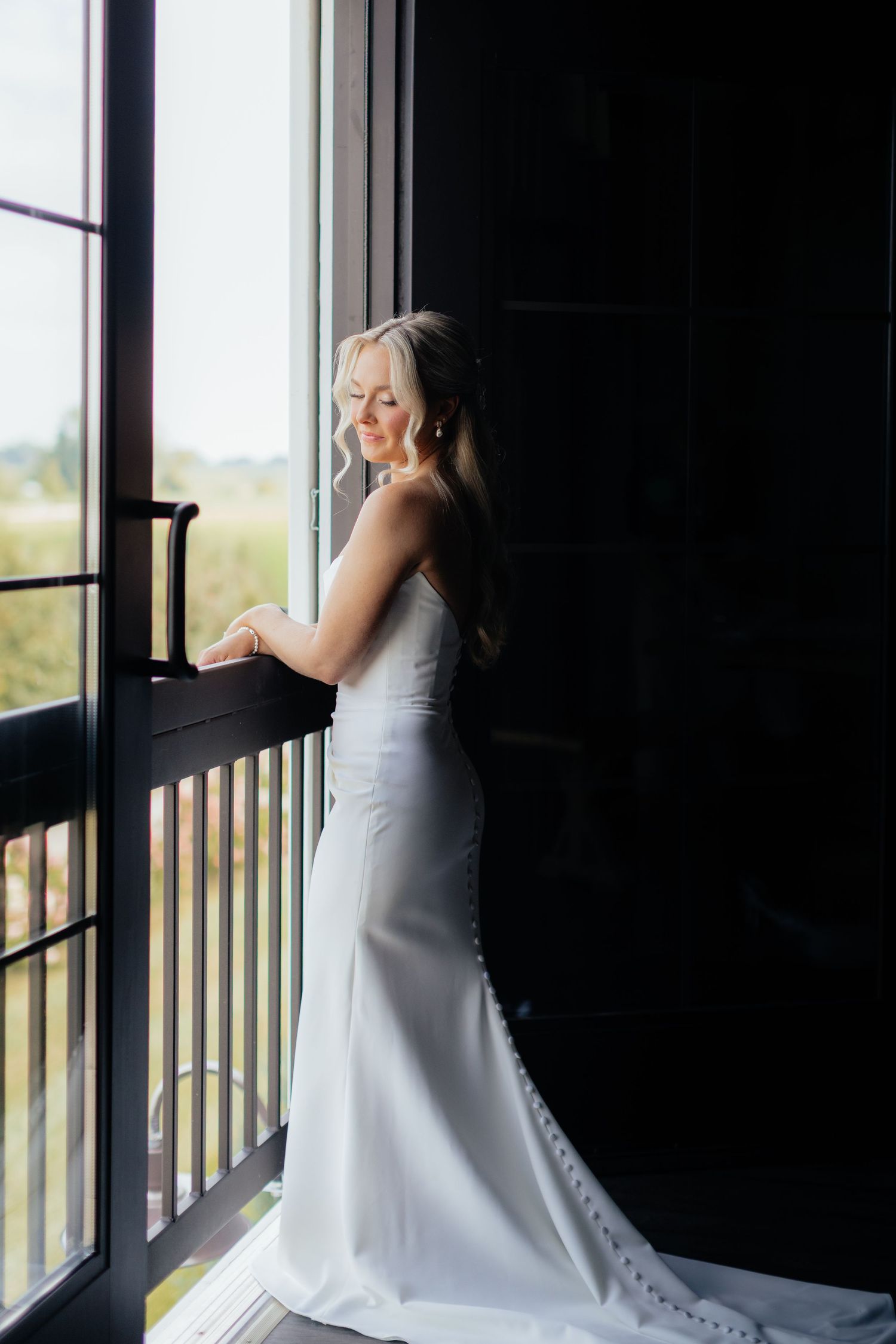 An elegant bridal portrait silhouetted against a bright window.
