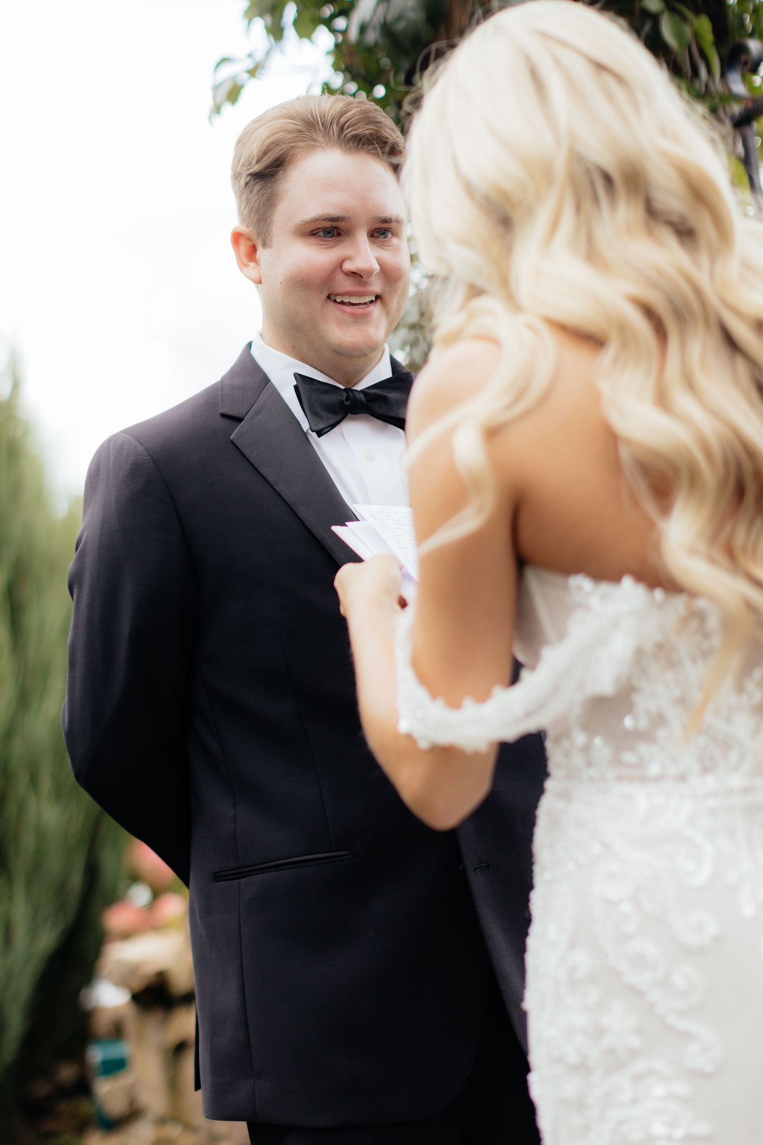 A joyful wedding moment captured between a couple during their outdoor ceremony.