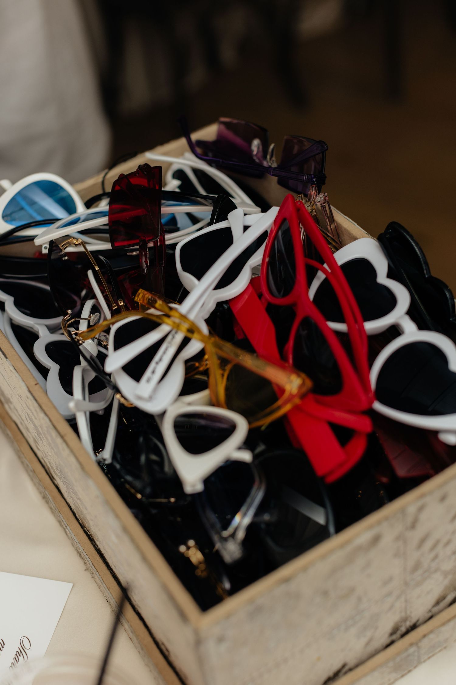 Collection of casual shoes arranged in a vintage wooden box.