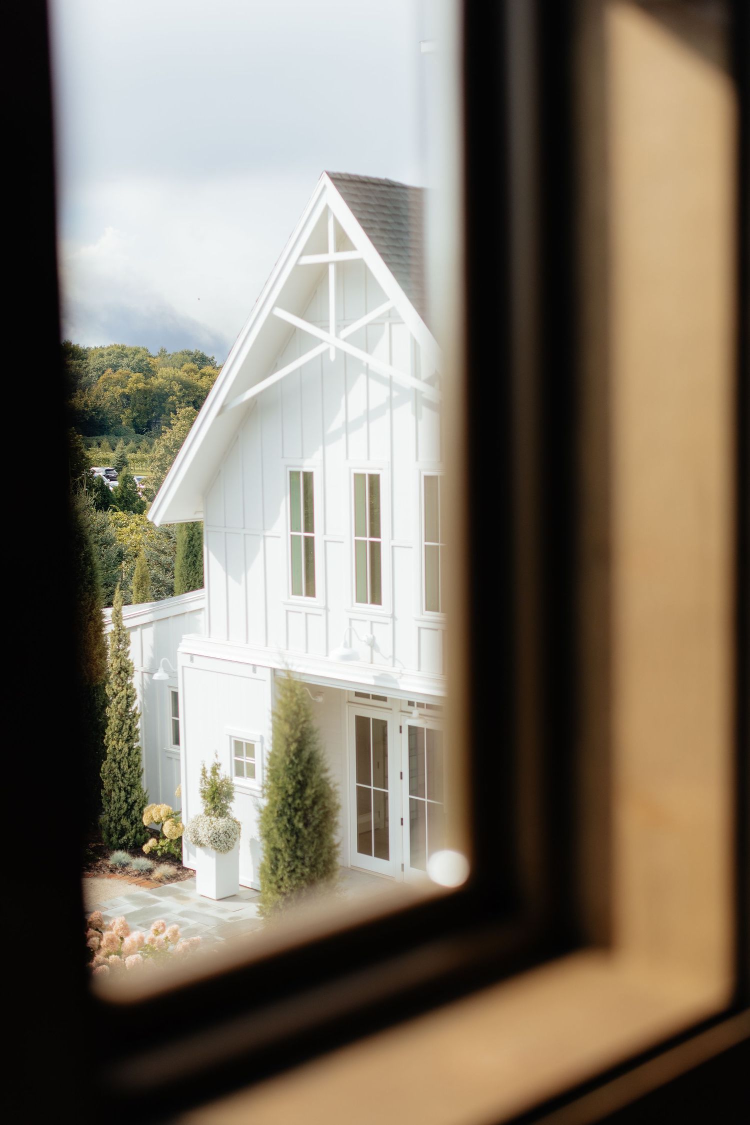 Modern white architectural buildings viewed through window frames.
