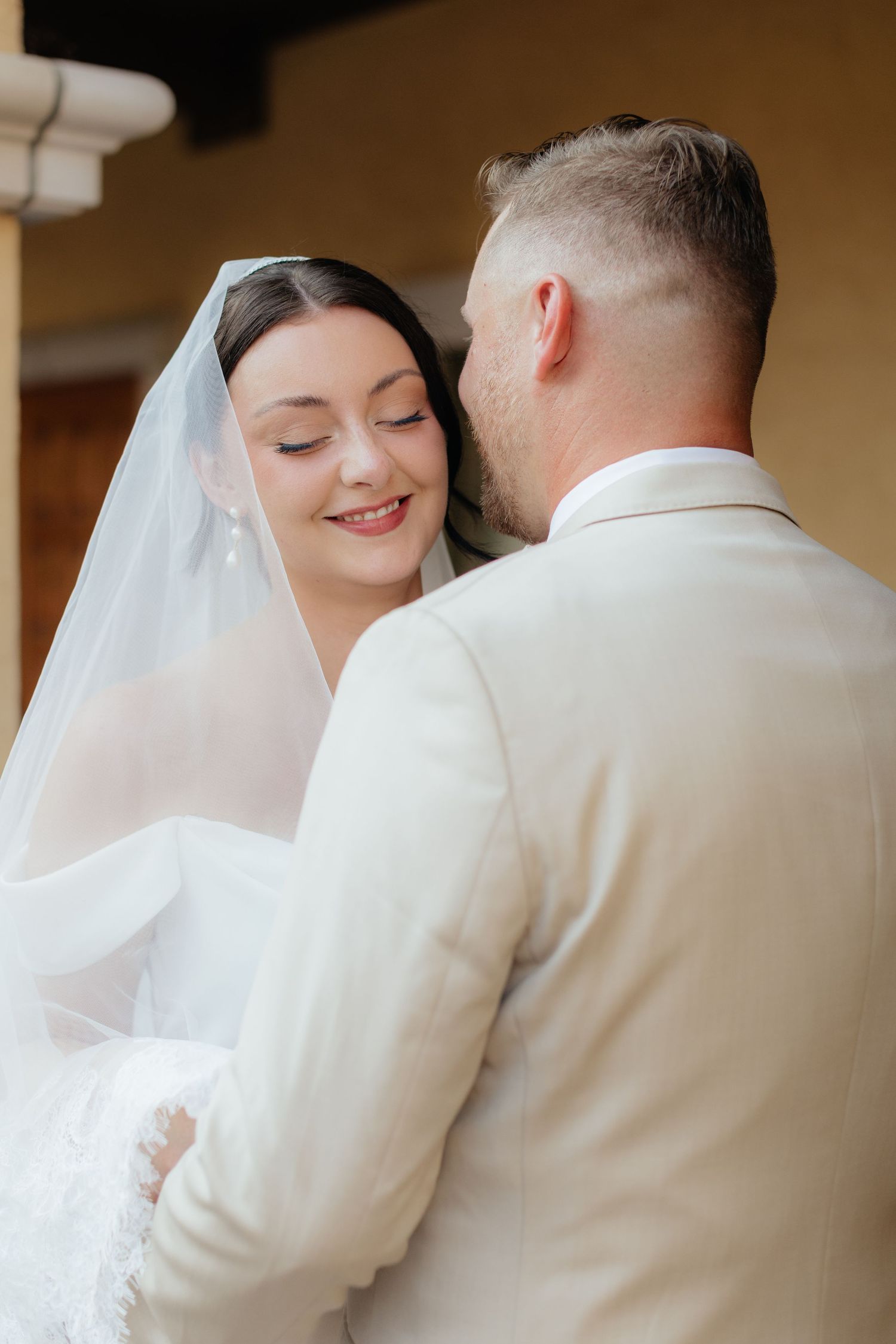 Soft focus intimate wedding portraits in warm tones showing tender moments.