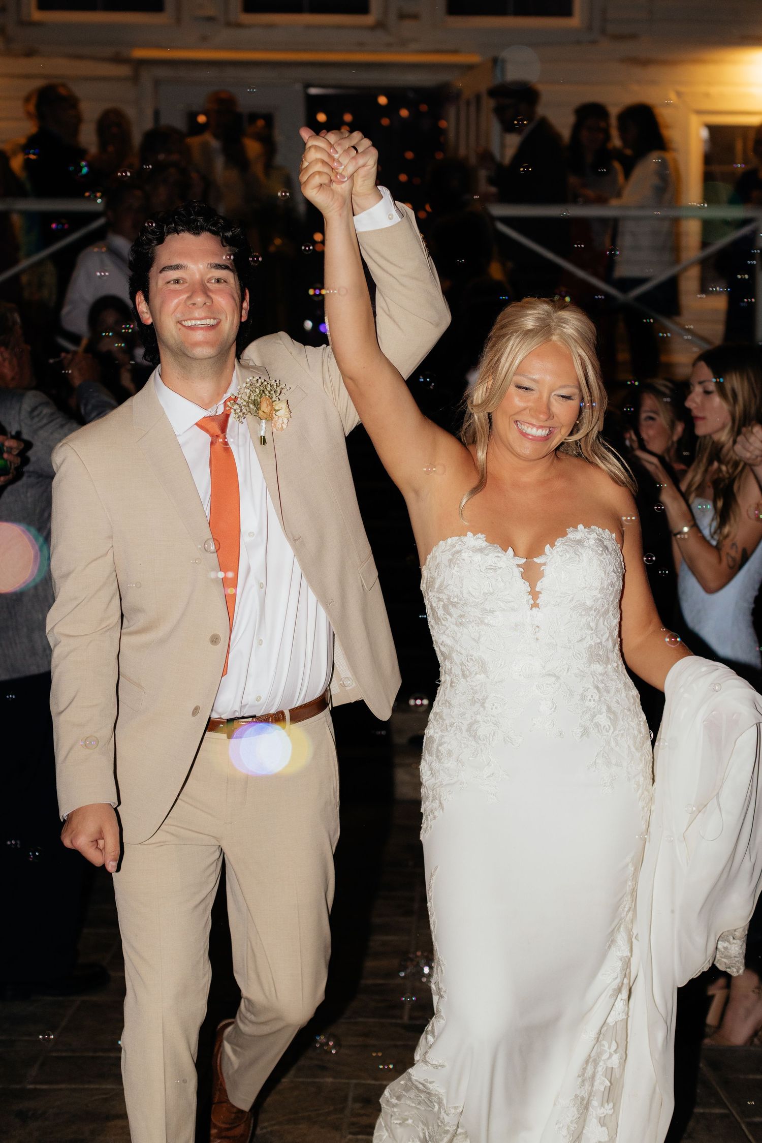 Joyful newlyweds dancing at indoor wedding reception.