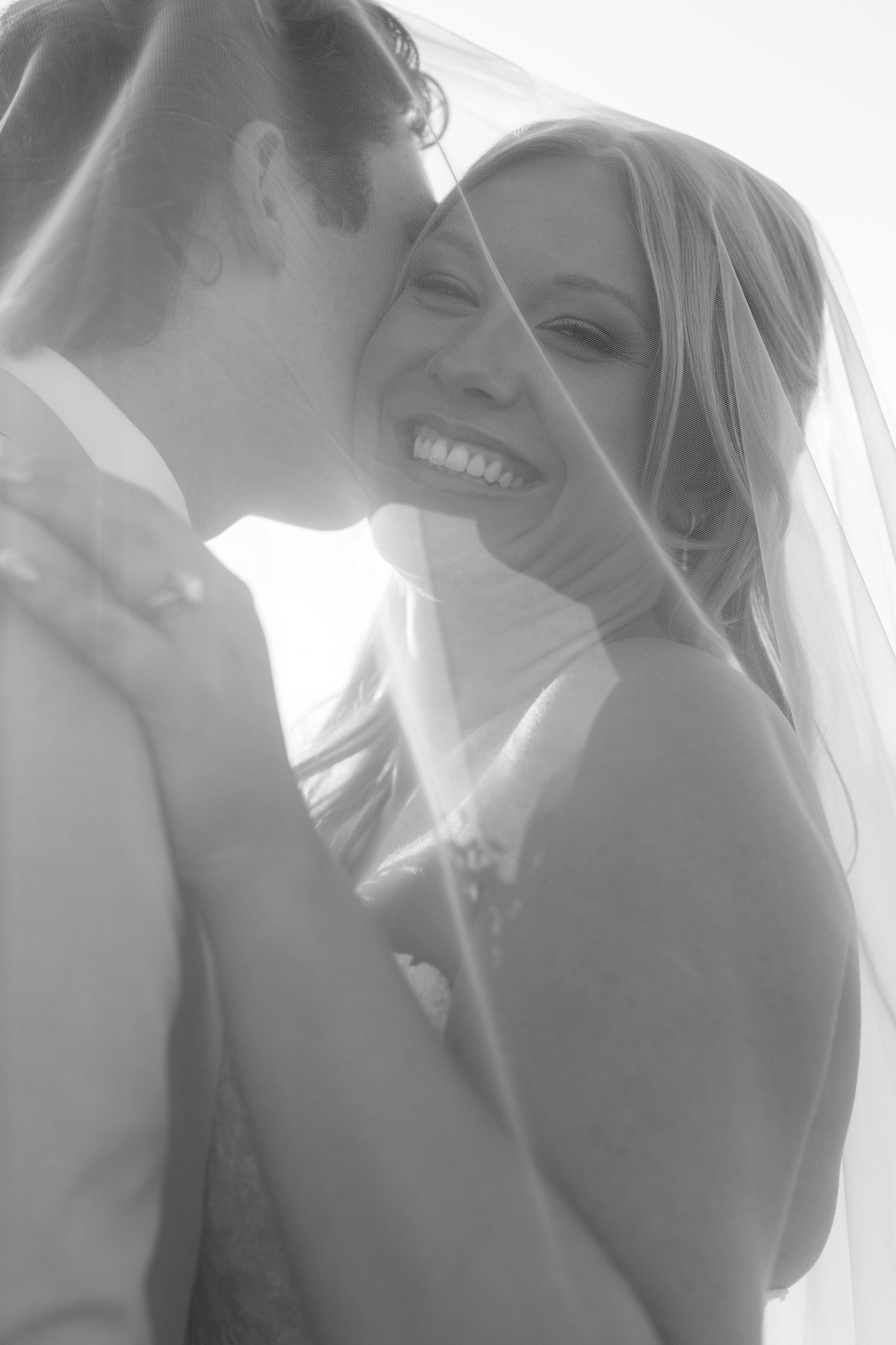 Romantic black and white wedding portrait series showing intimate moments between newlyweds.