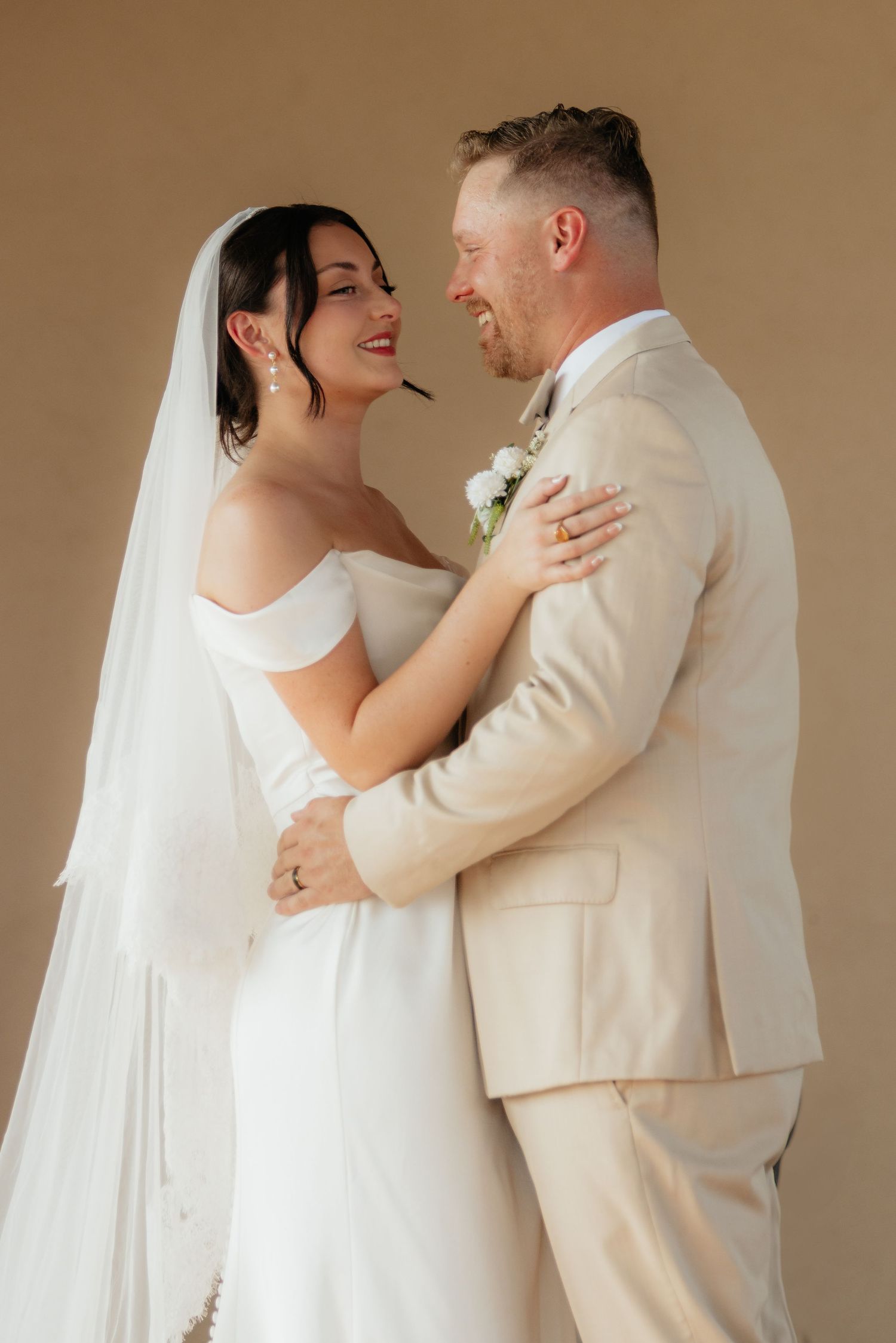 Candid sequence of wedding couple embracing and laughing together in formal attire.