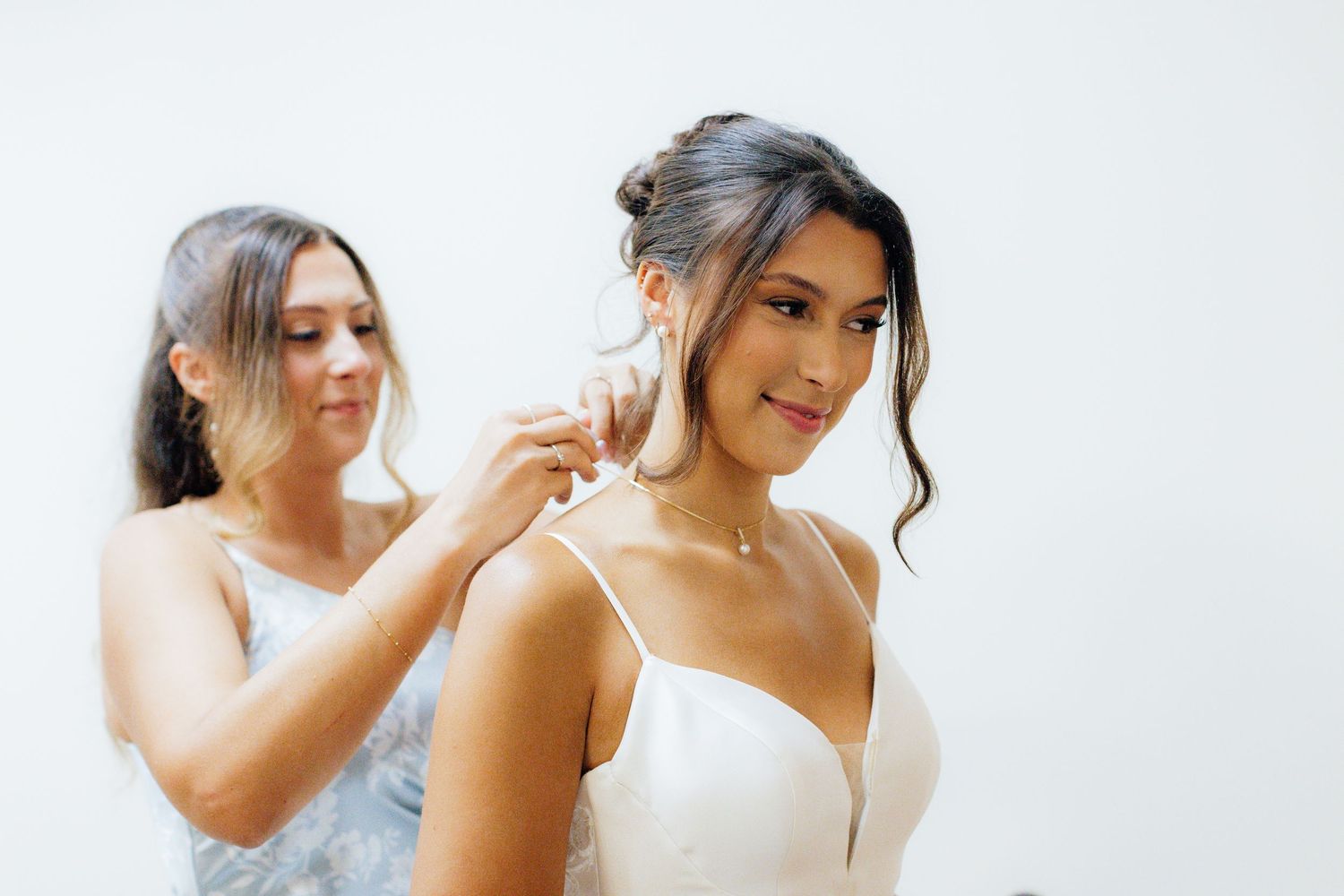 Getting ready scene with wedding preparations in a bright white room.