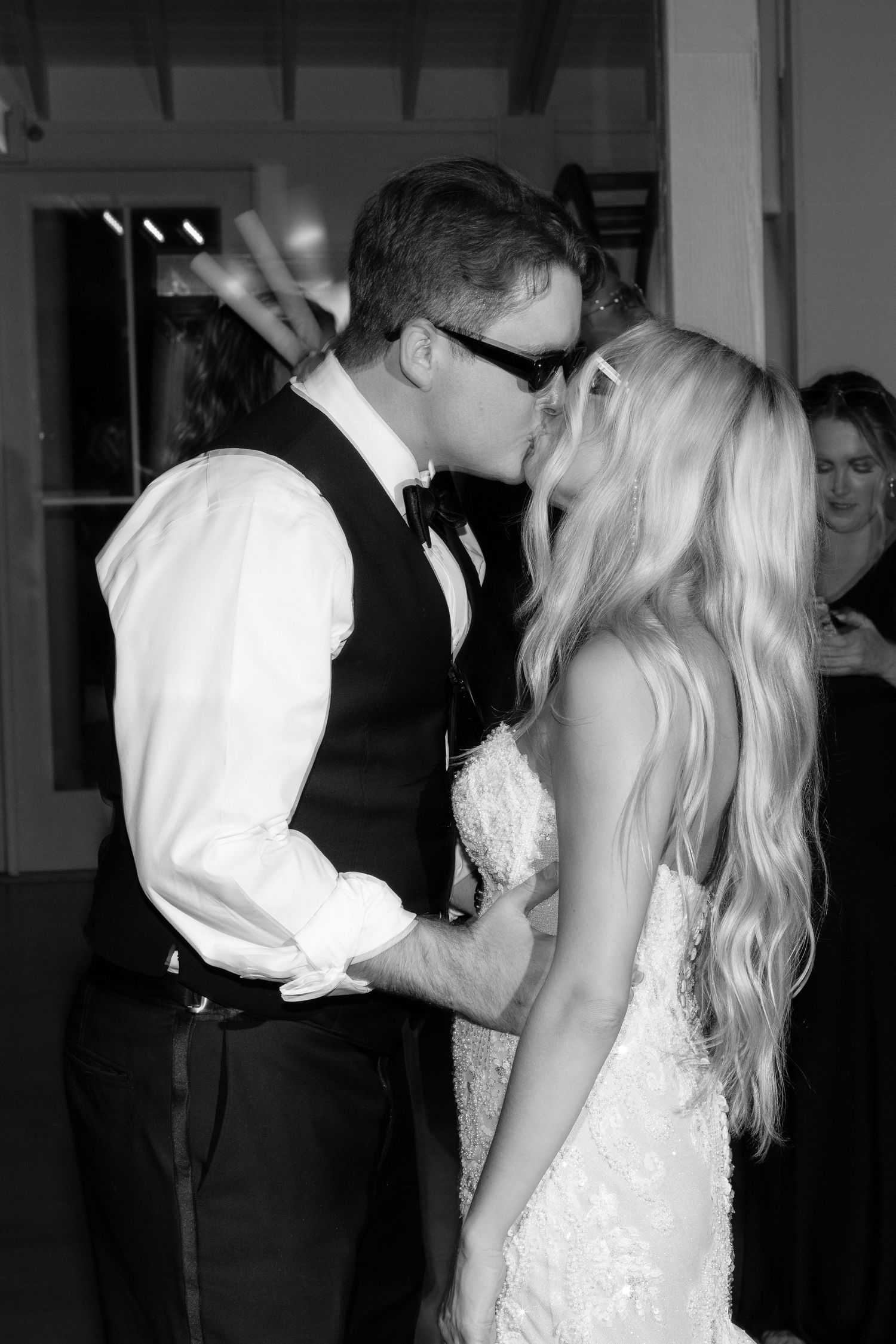 Black and white photo of wedding couple sharing an intimate dance moment.