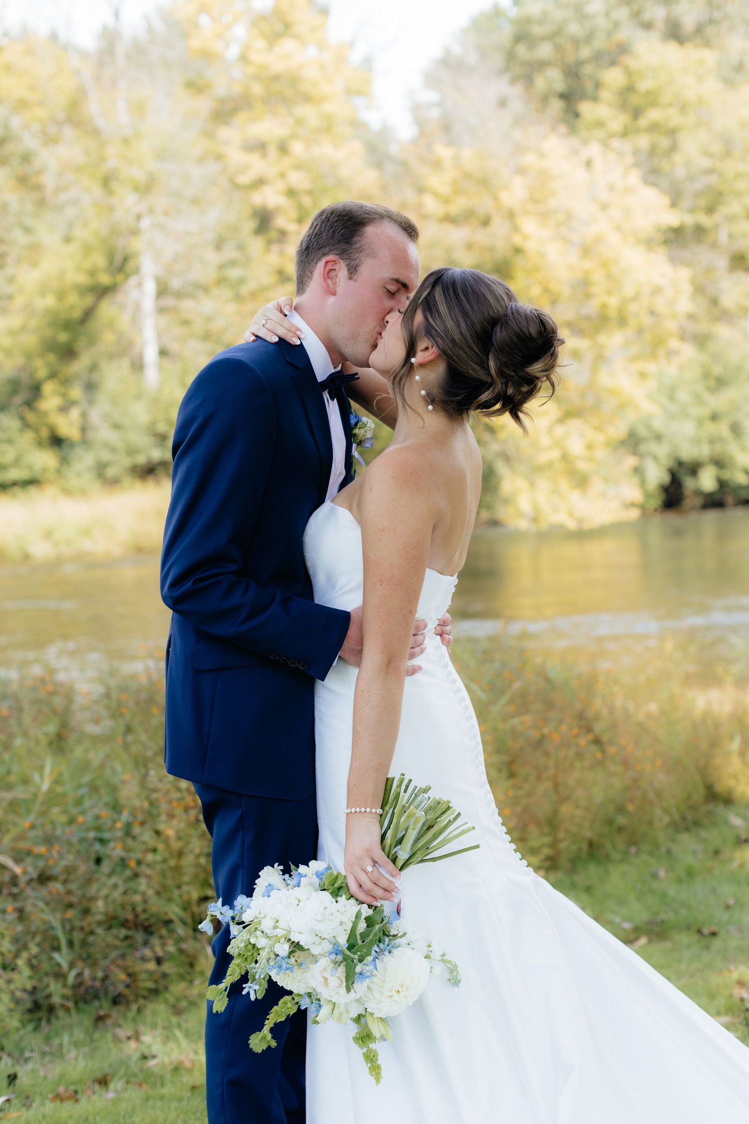 Newlyweds share intimate moment during outdoor wedding photoshoot.