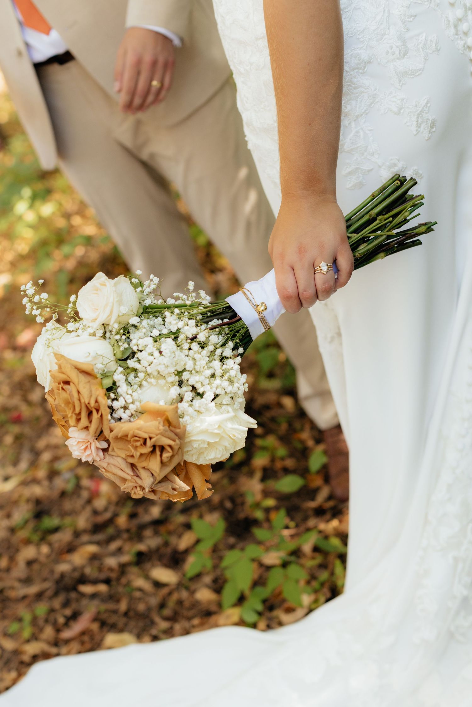 Detail shots of wedding bouquets with white flowers and greenery against white dress.