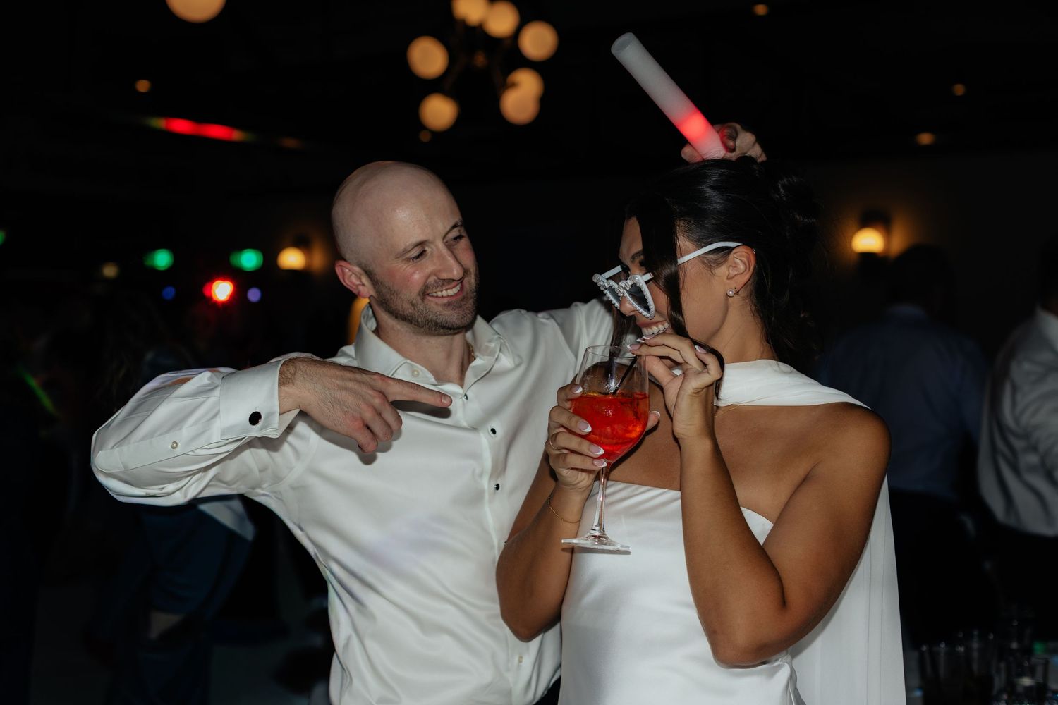 Wedding party members sharing drinks and celebrating at a reception party.