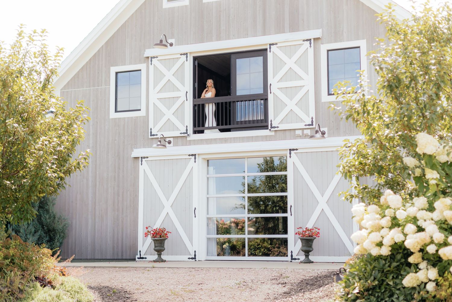 A charming barn venue with white trim and decorative barn doors.