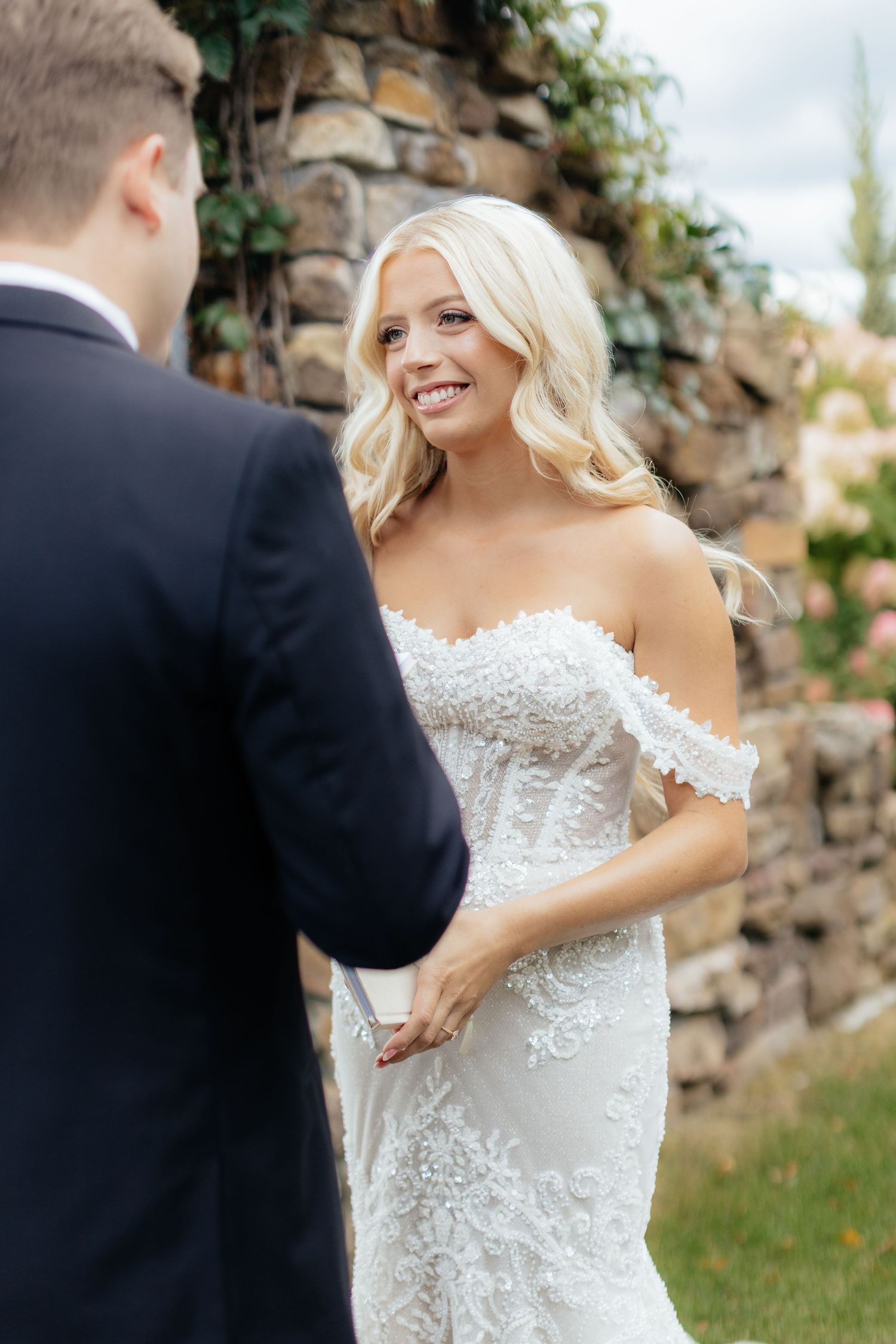 A candid moment of joy shared between a couple during their wedding ceremony.