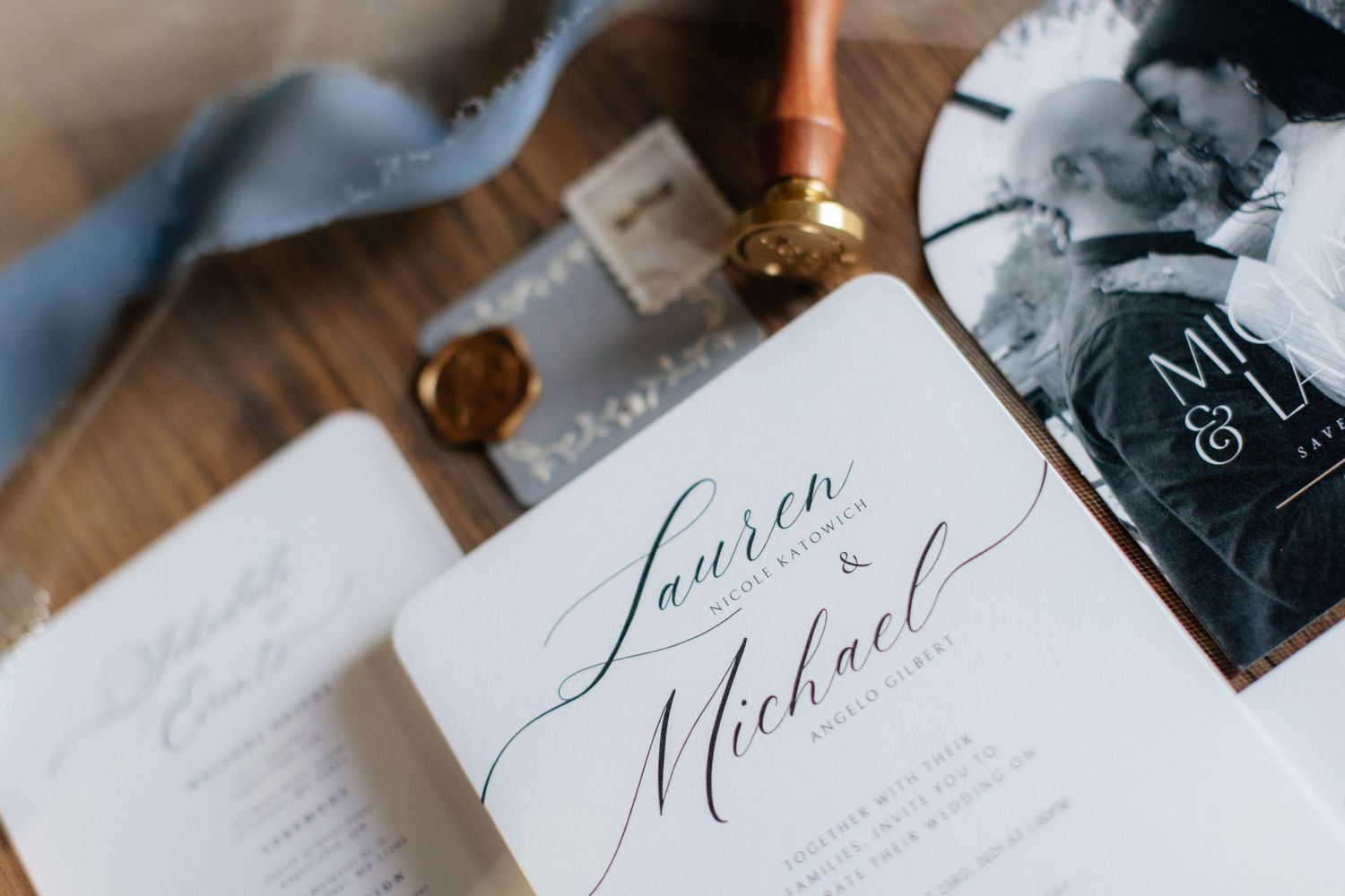 Elegant wedding invitation suite with calligraphy and wax seal details.