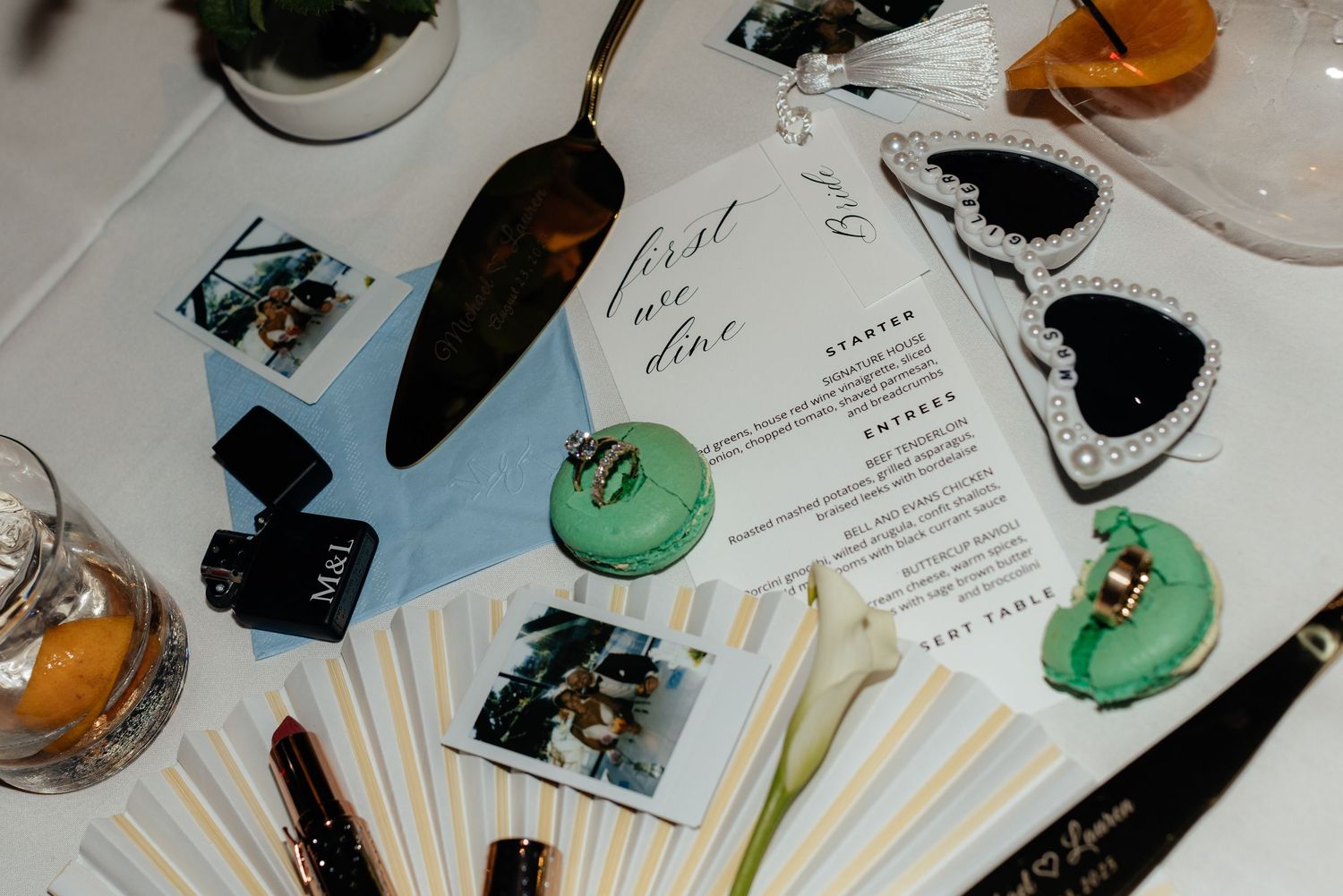Wedding reception table settings with menus and decorative elements.