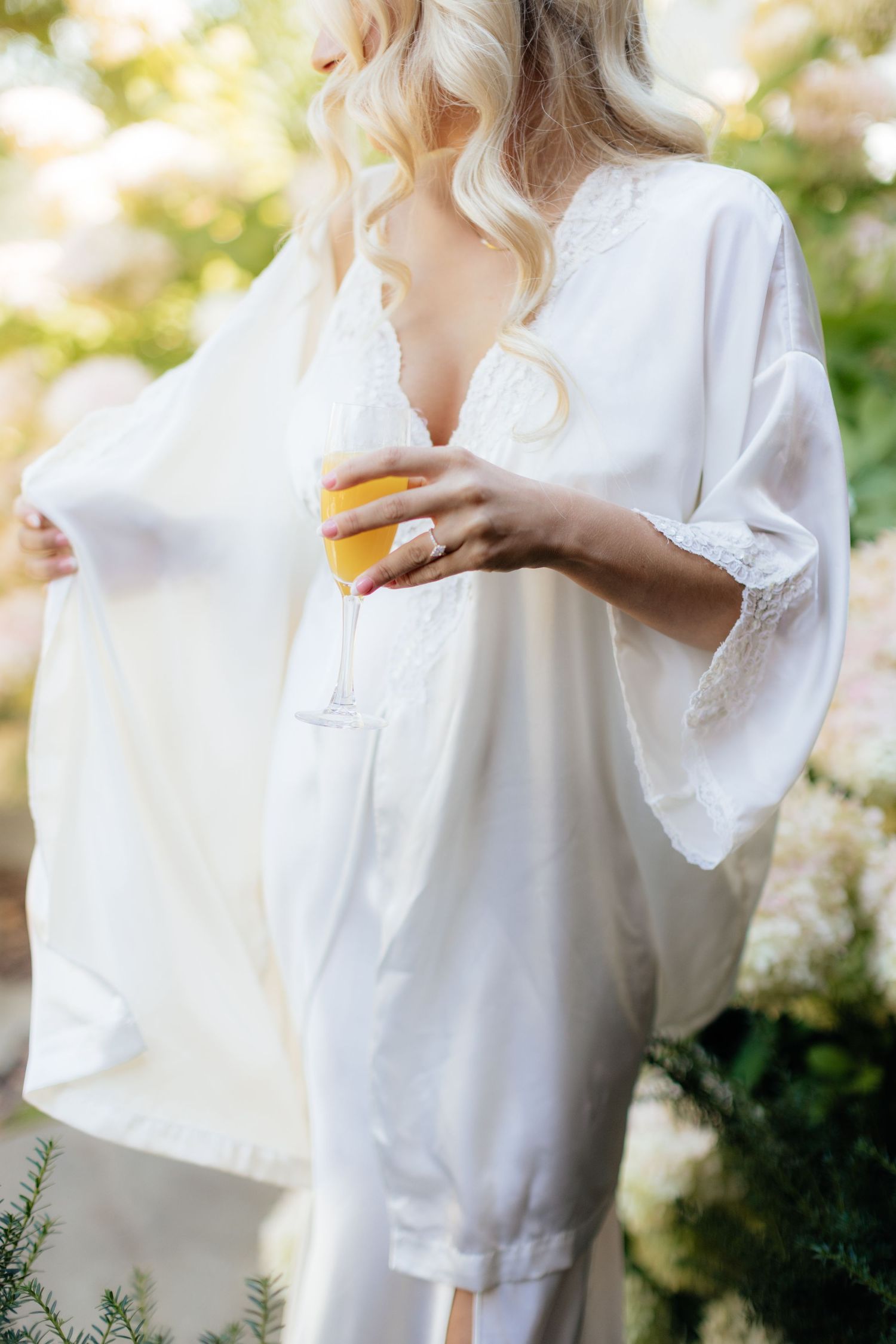 White silk bridal robe captured in soft morning light during wedding day preparations.