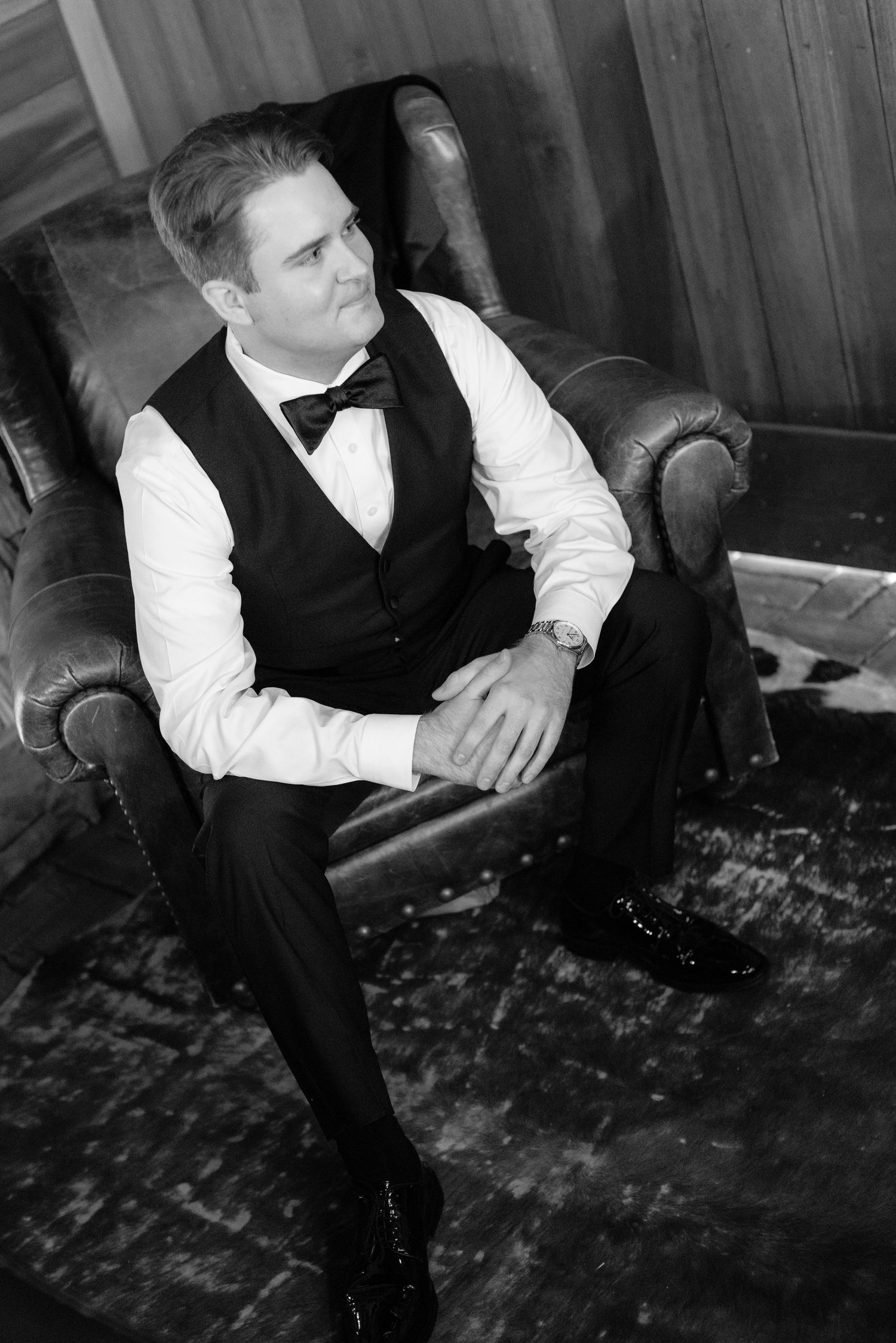 Black and white photo of formal attire and preparations in a rustic setting.