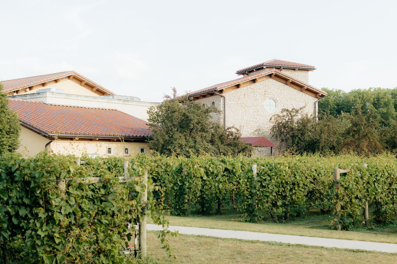 Scenic view of Mediterranean style buildings with terracotta roofs and lush greenery.