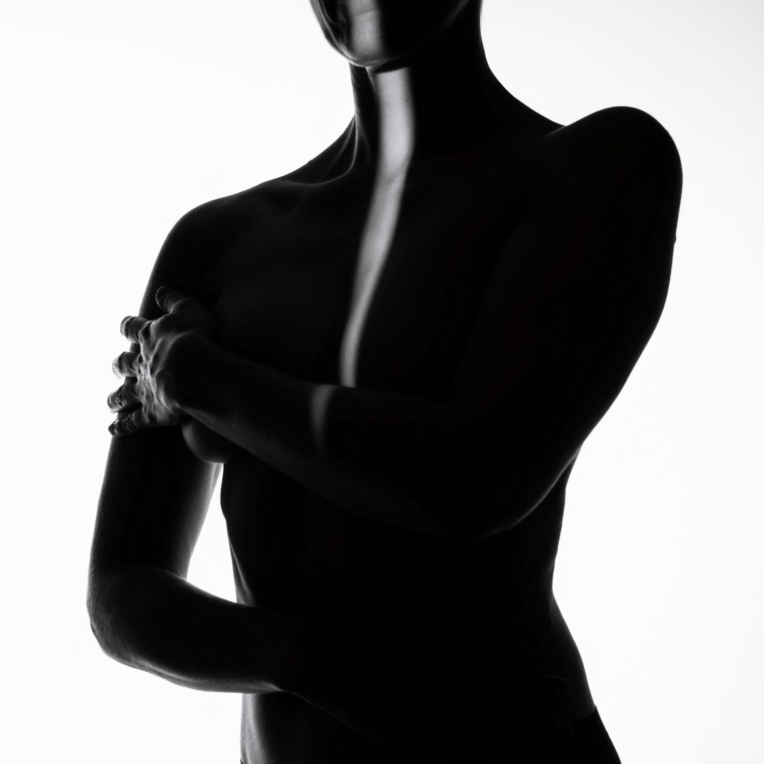 Minimalist black and white silhouette of a woman crossing her arms against a white background.