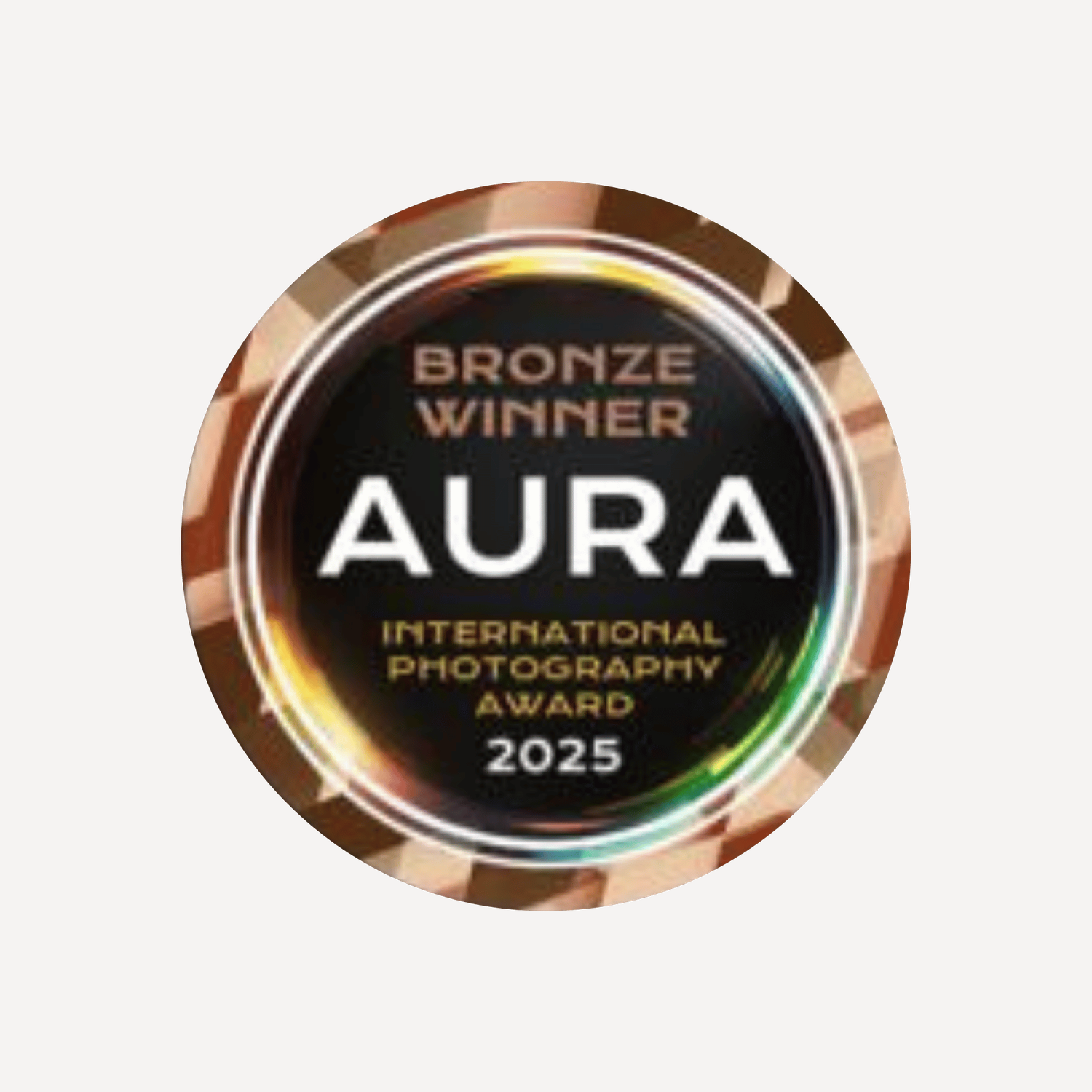 Bronze Winner badge for the AURA International Photography Award 2025, featuring a metallic circular design.