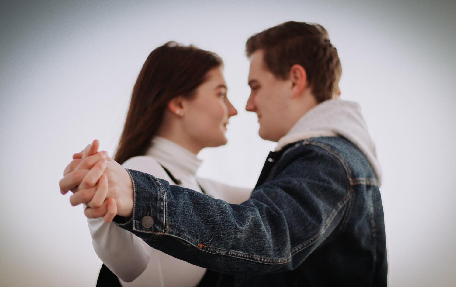 Couple holding hands towards camera