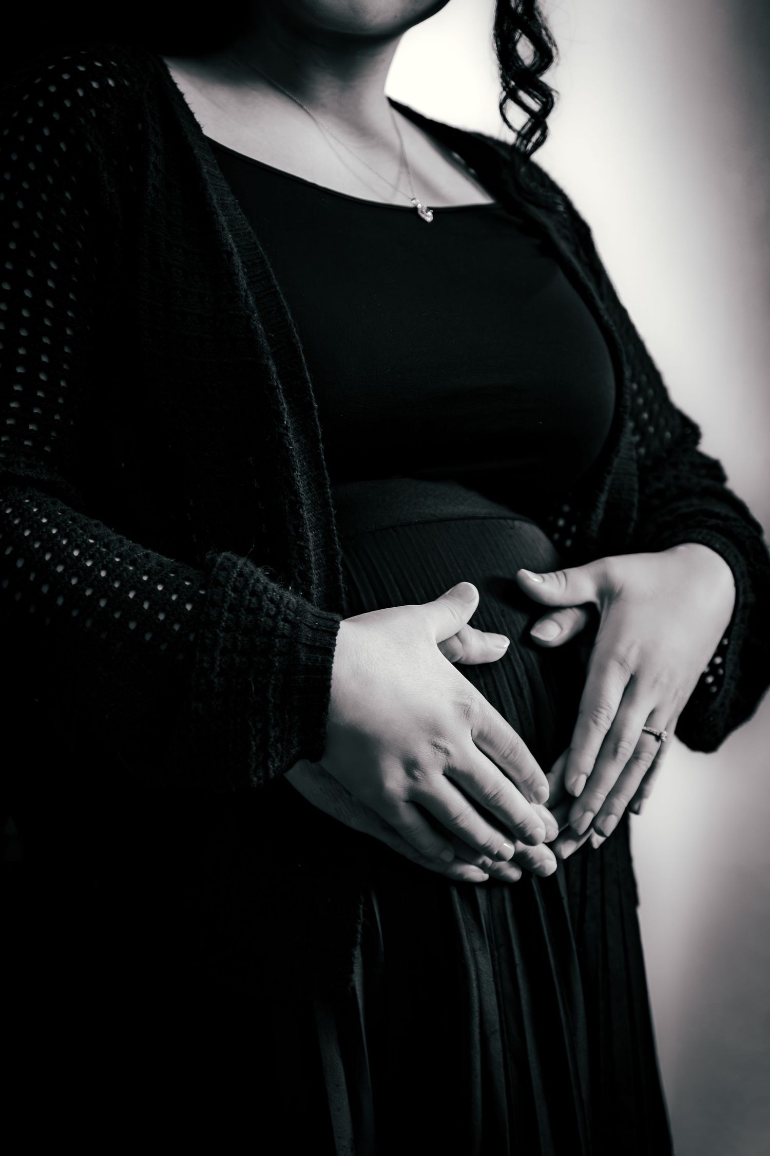 Women with hands placed over pregnant belly