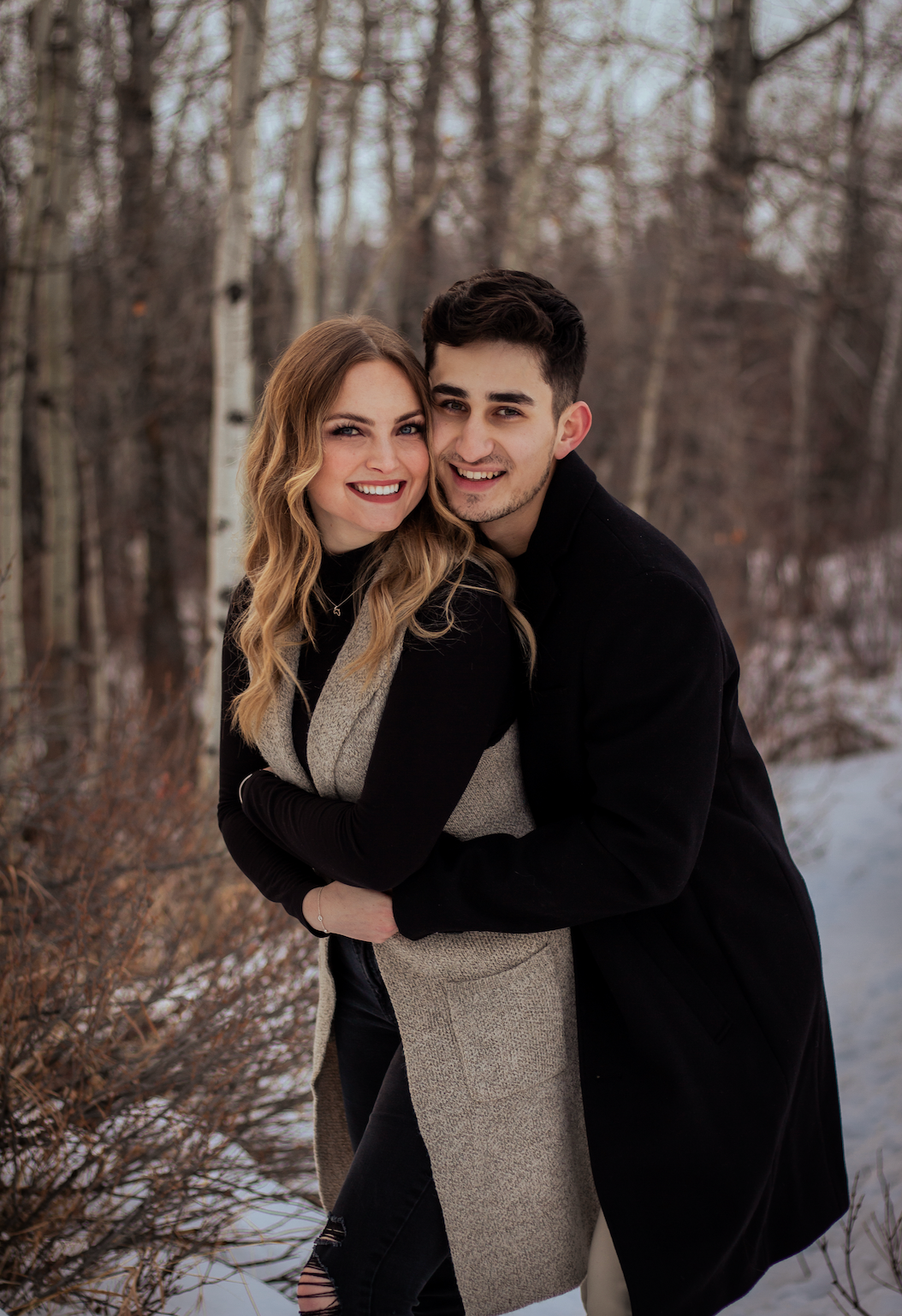 Man hugging women from behind while smiling