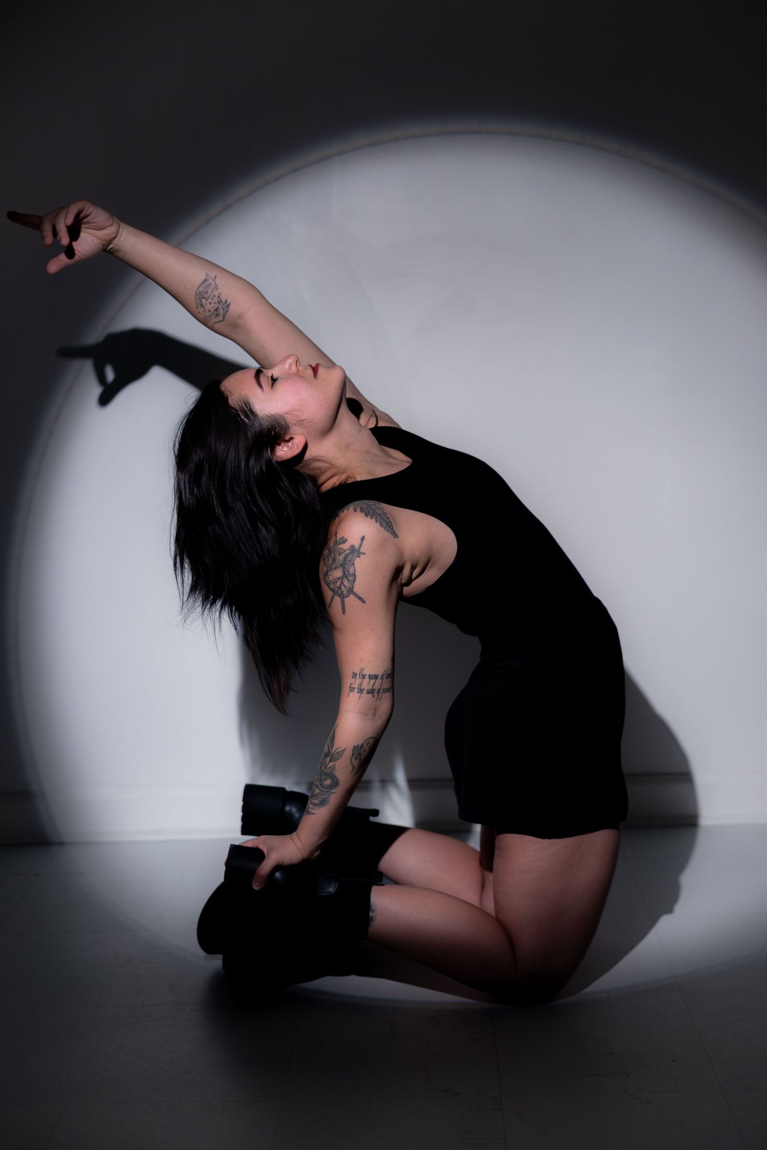 Dramatic studio portraits on dark background showing expressive dance-like poses.