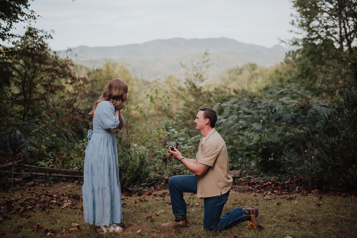 Marriage proposal moment captured on scenic mountain overlook.