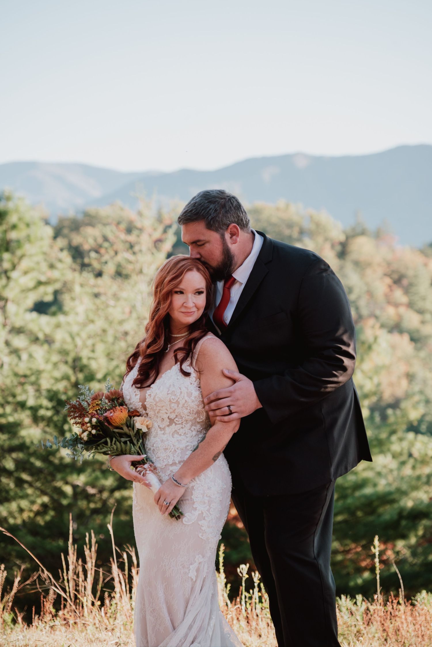 Intimate wedding portraits captured in golden mountain meadow during sunset.