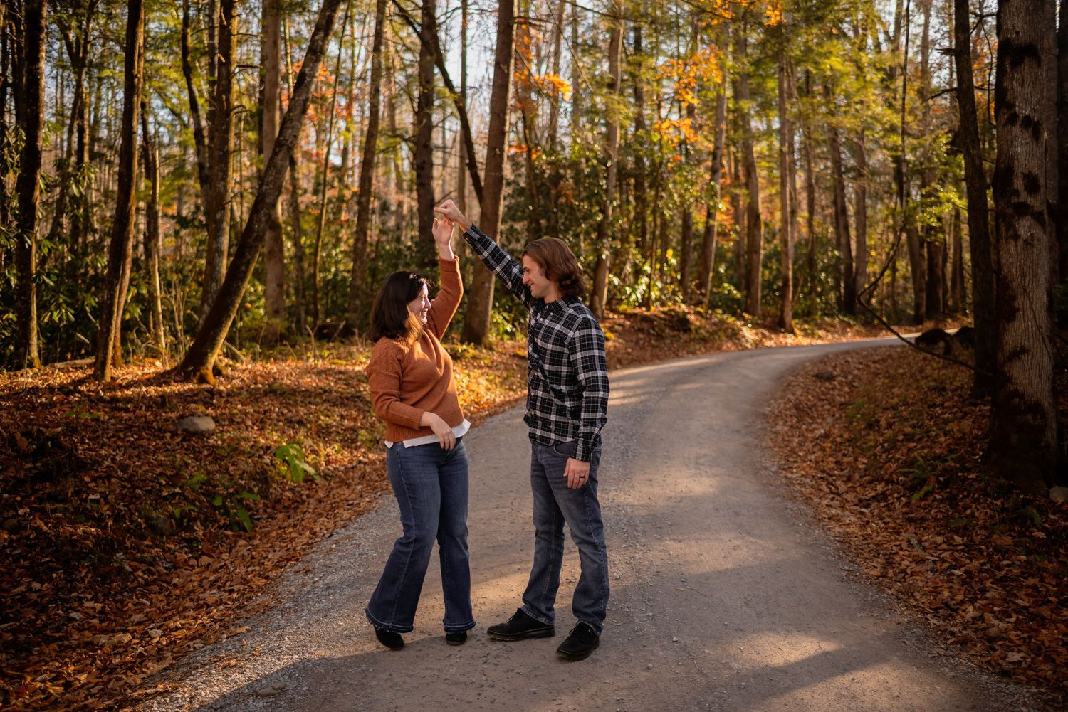 Series of walking poses along tree-lined autumn path with fallen leaves.
