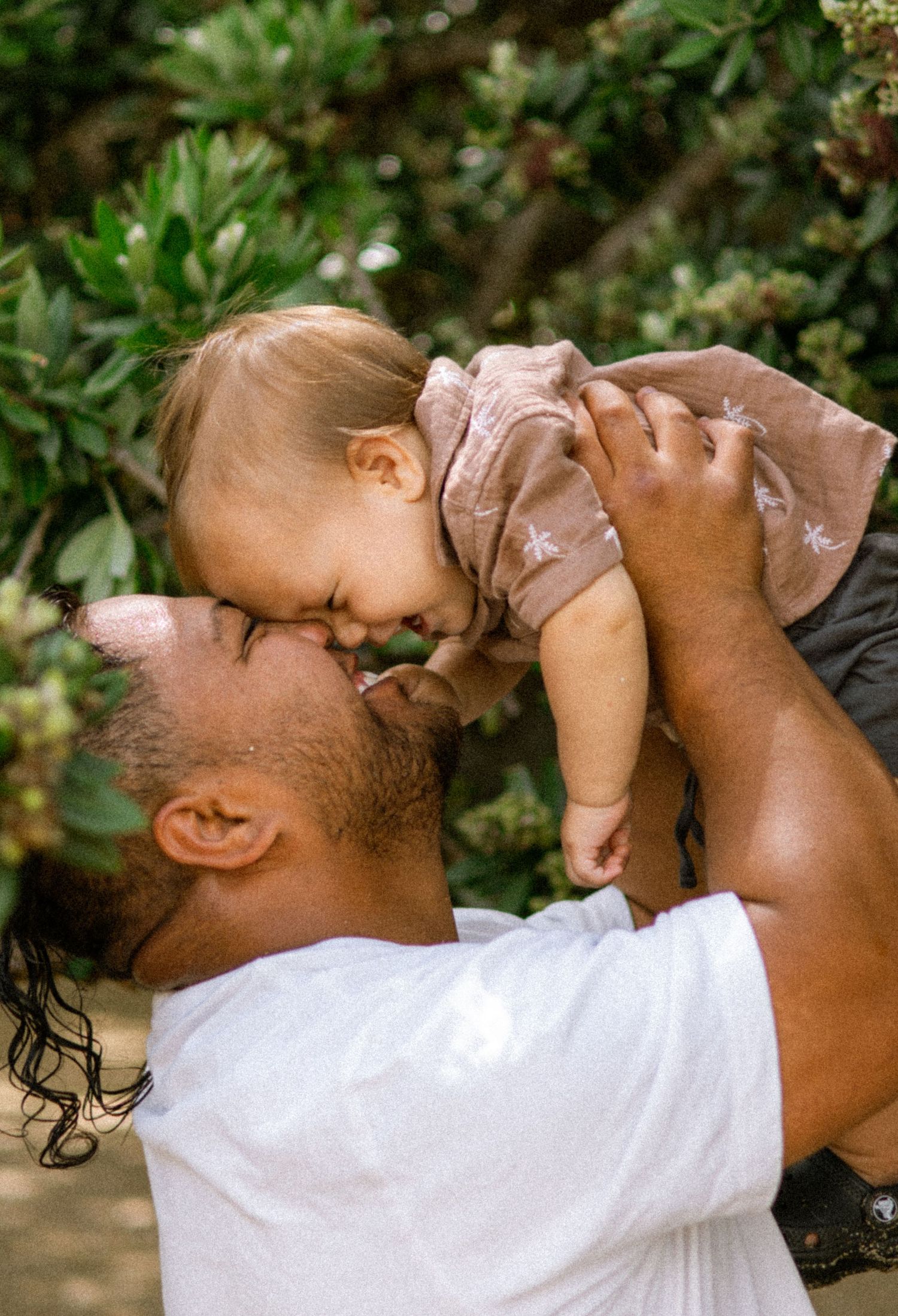 A series of playful moments between parent and child with lifting and hugging.