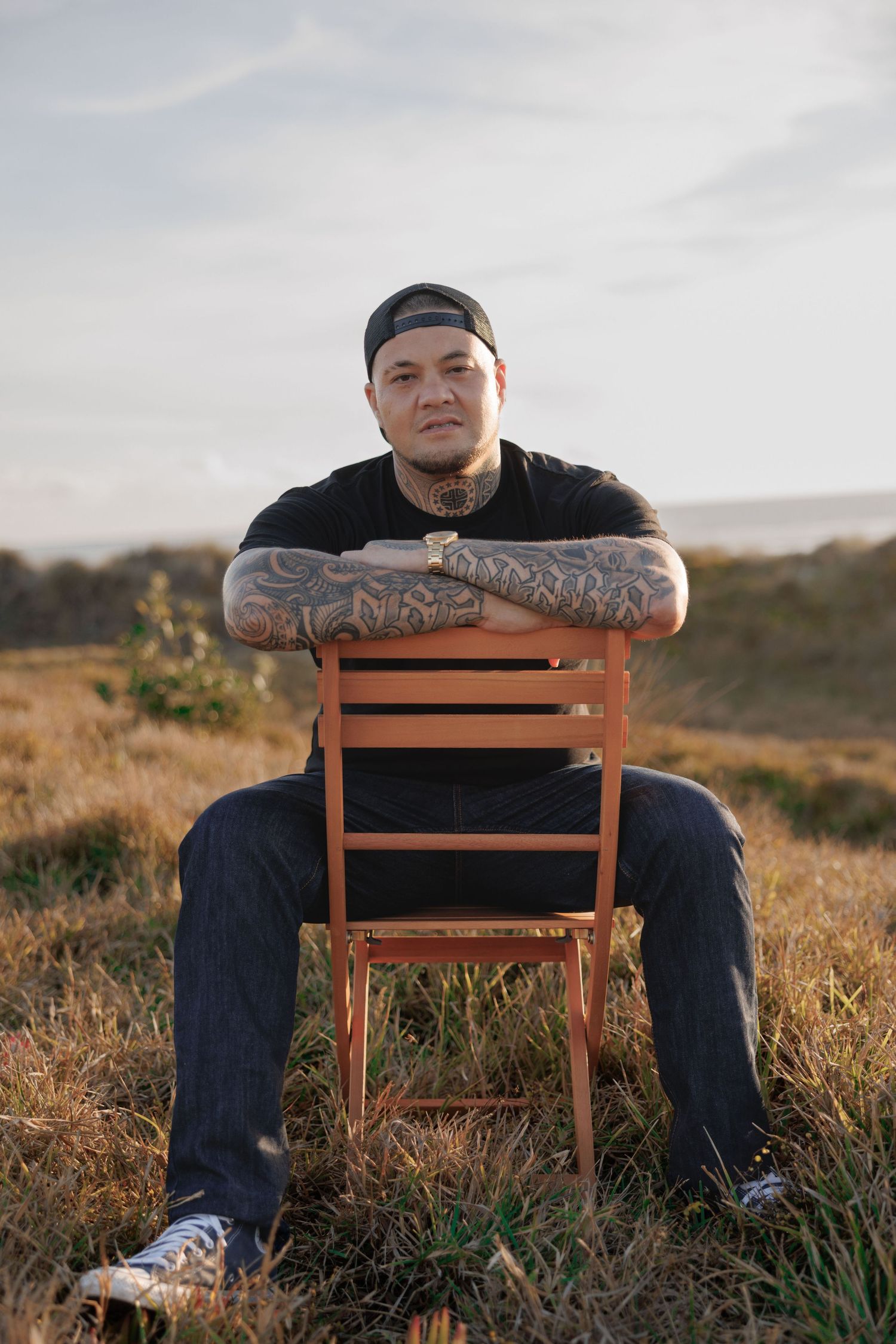 A series of photos showing someone sitting on a wooden chair in a grassy field at sunset.
